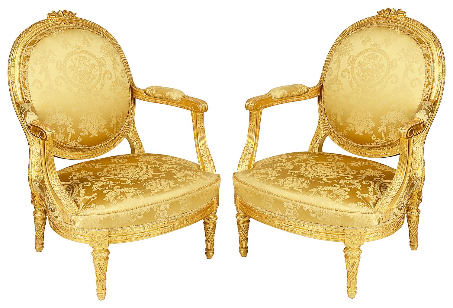 A very impressive good quality 19th century carved giltwood French Louis XVI style salon suite, consisting on a sofa and a pair of arm chairs. Each having moulded to the show wood frame, leaf ribbon decoration, classical silk damask fabric and