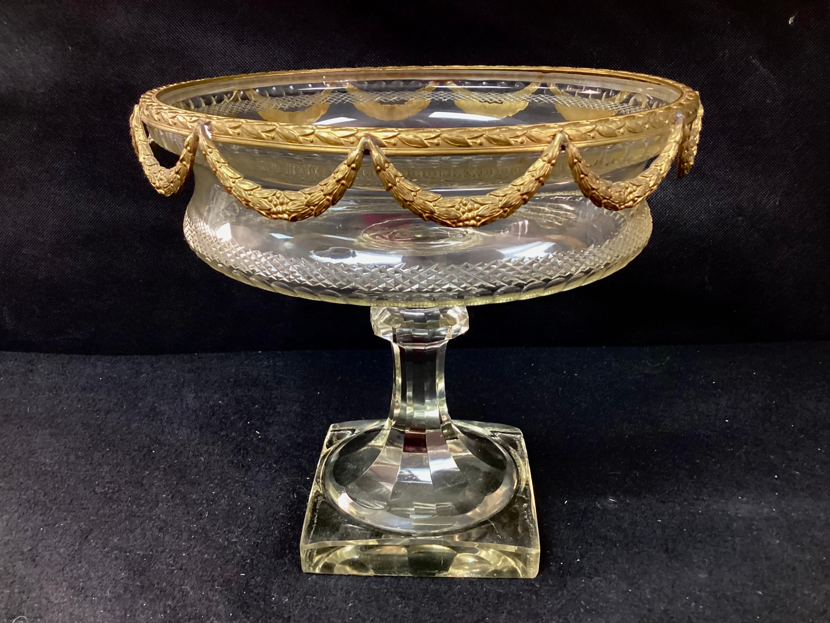 Louis XVI style large French cut lead crystal and ormolu bronze pedestal centerpiece/bowl. Features hand-cut crystal with gilt bronze top trim. Attributed to Baccarat. Can be use to hold fruit, as a decorative display, or as a centerpiece for a