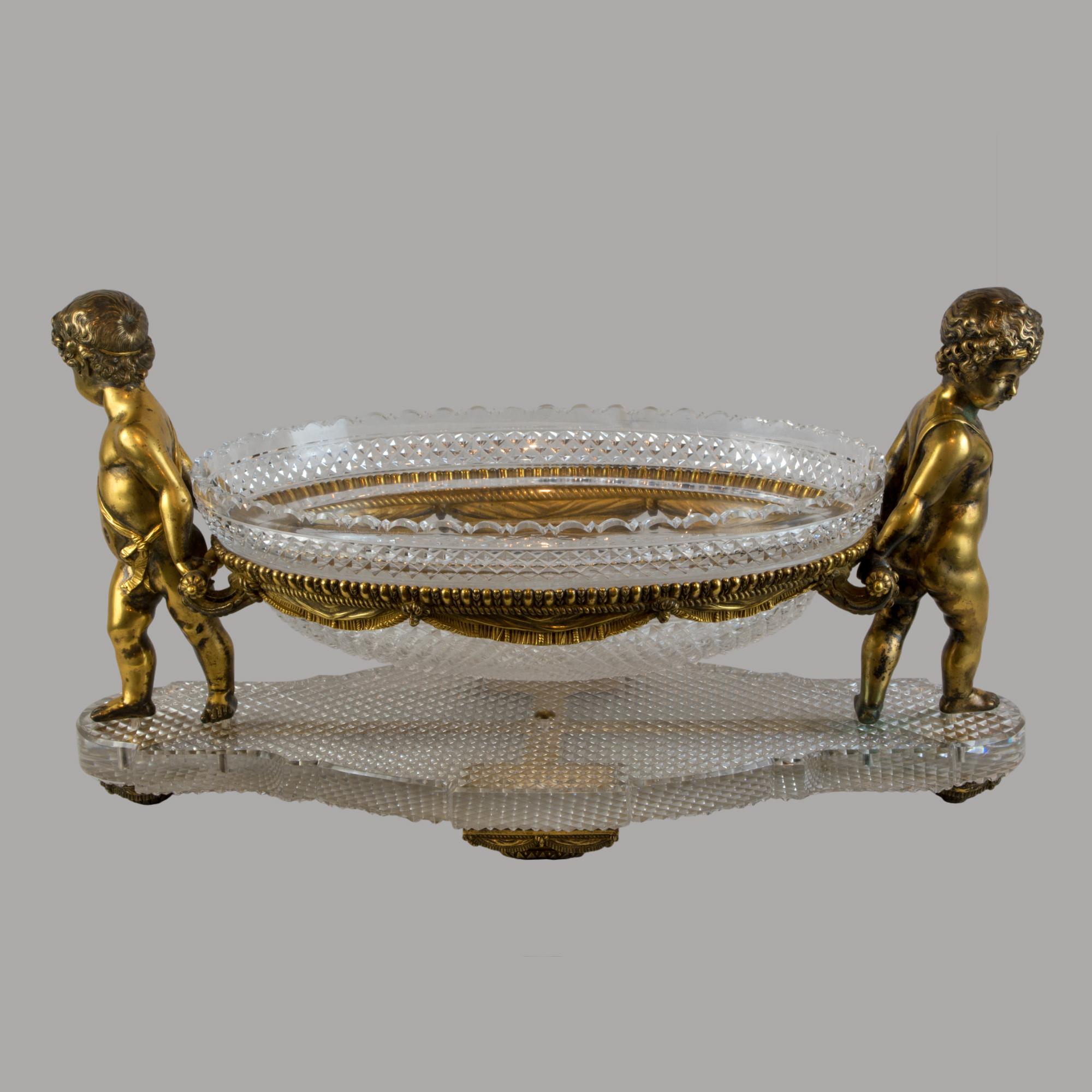 Important Louis XVI Style Gilt-Bronze and Cut Glass Figural Centerpiece att. to Baccarat 

An important centerpiece reflective of French luxury, in the opulent Louis XVI style, attributed to the esteemed Baccarat house, dating back to the 19th