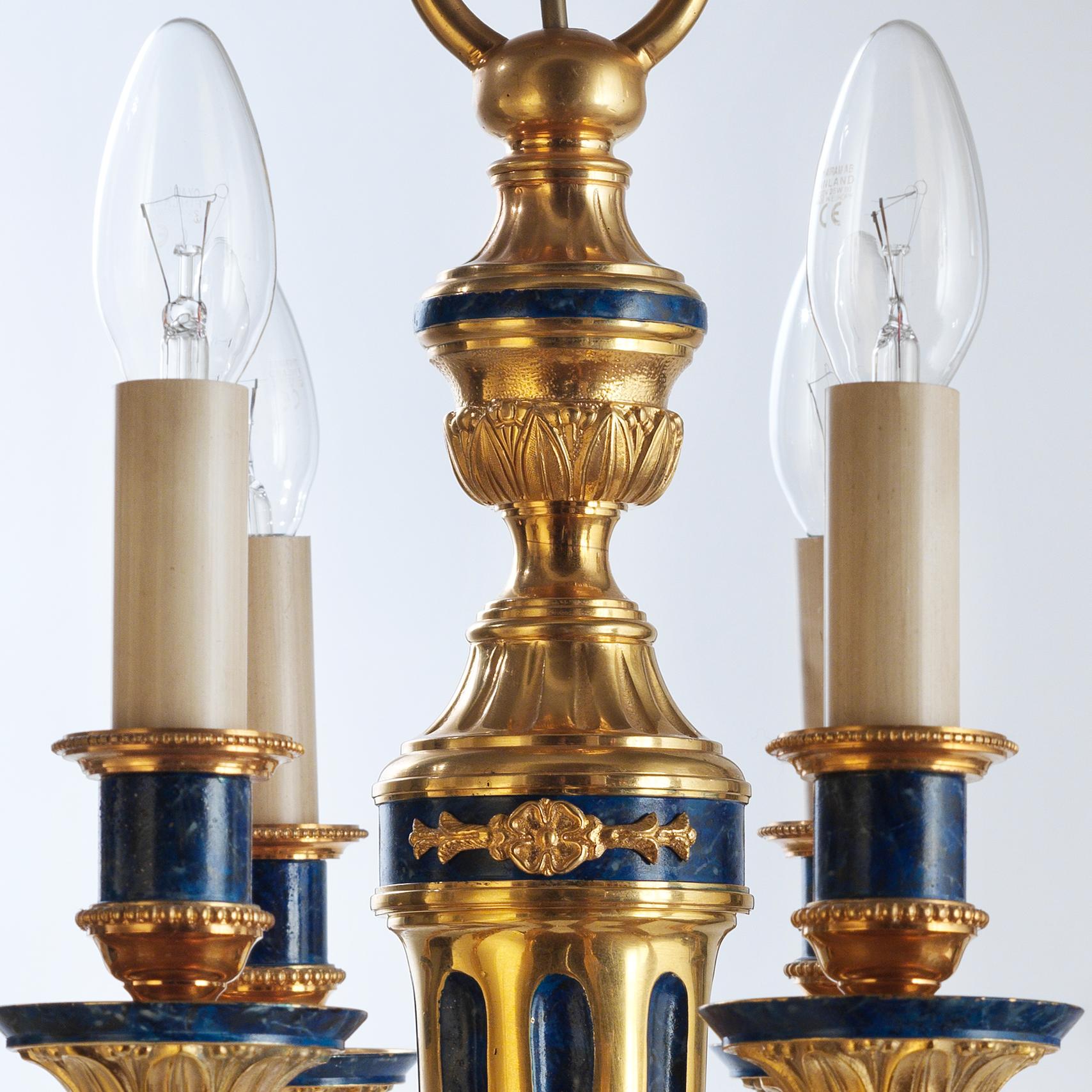 This Louis XVI style chandelier by Gherardo Degli Albizzi is derived from a typical wall sconce model of that period. It's possible to appreciate the handcrafted work of gilt bronze decorations such as vegetal and fruit motifs all-over. At the