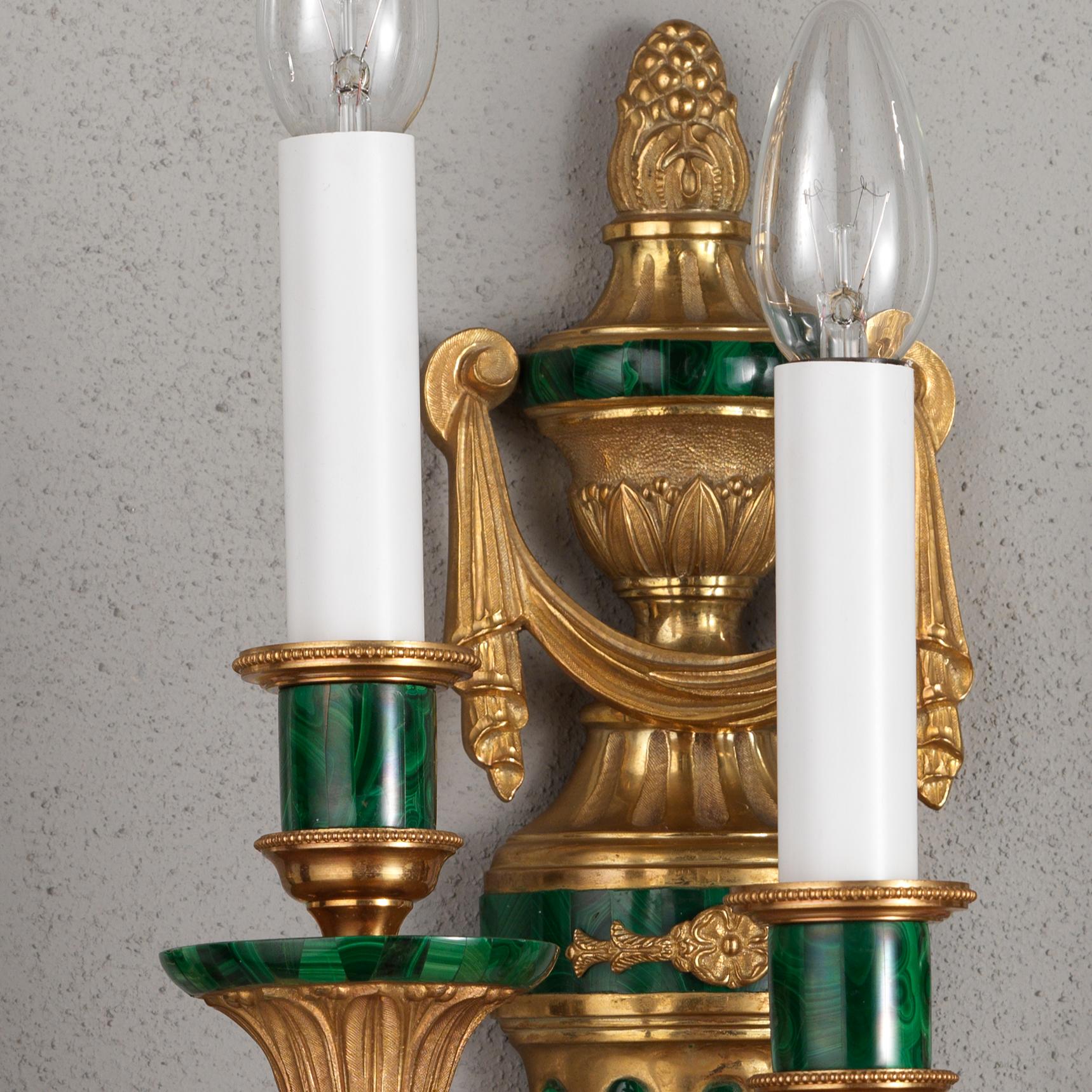 This Louis XVI style gilt bronze and malachite veneer wall sconce by Gherardo Degli Albizzishows many high quality hand chiselled details, enriched by Malachite veneer. At the top there is an urn with a pine finial and a drapery decoration.
Below