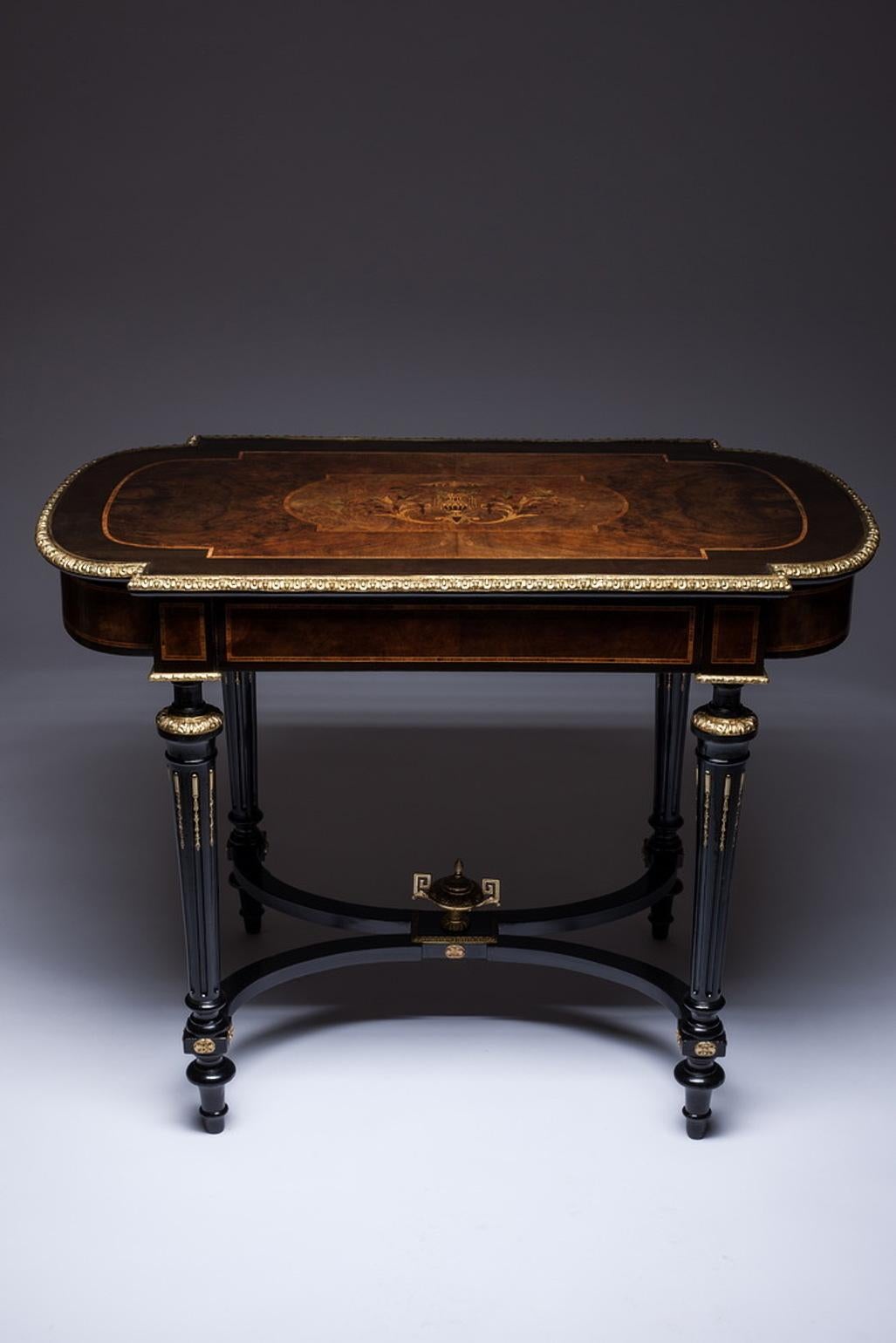 A fine French 19th century Louis XVI style ebonized gilt bronze-mounted tulipwood, kingwood and fruitwood floral marquetry single-drawer center table, desk or writing table. The ornately decorated marquetry top, centred with a floral bouquet,
