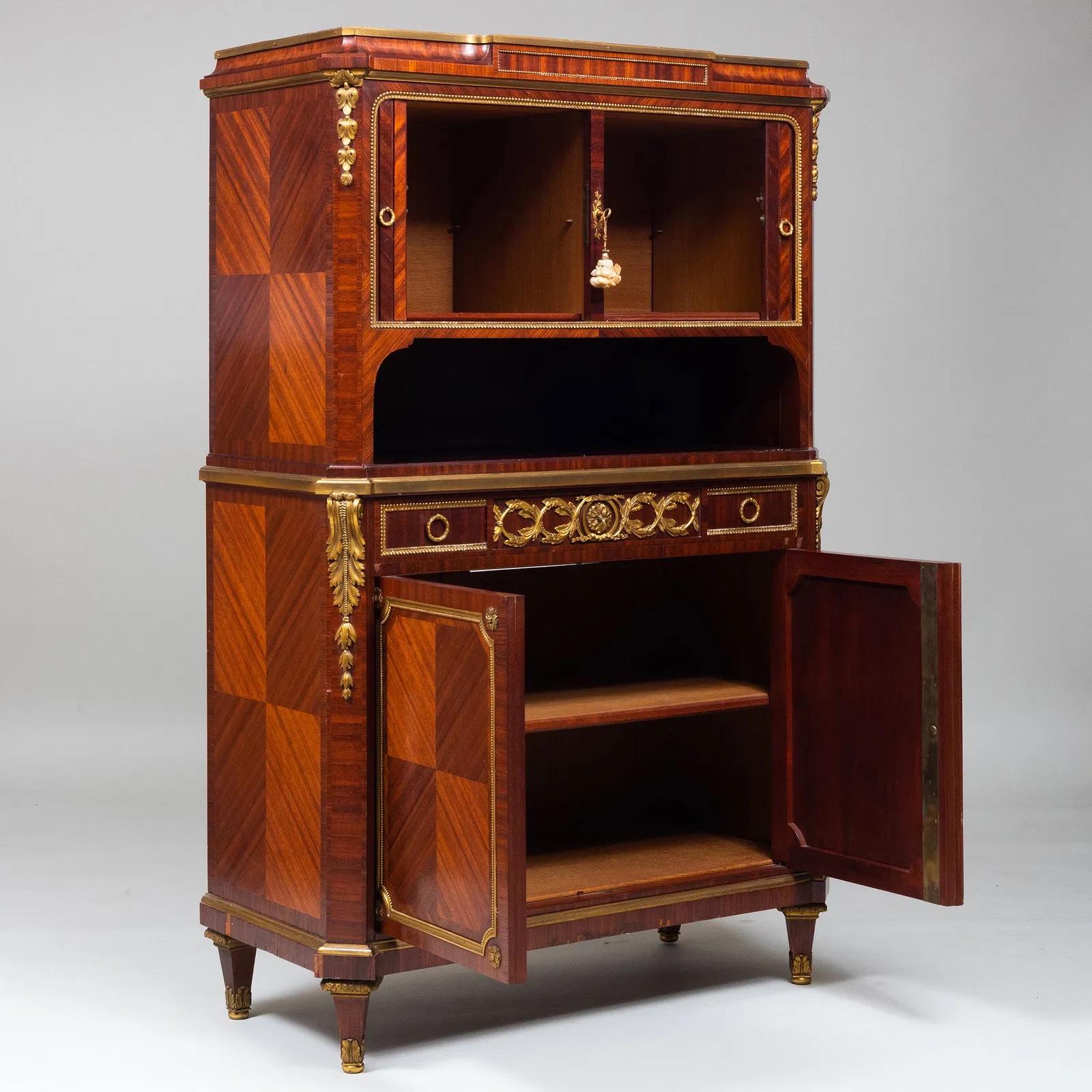 Louis XVI style gilt bronze mounted and mahogany marquetry cabinet. The top opening with two rolling doors and lower section opening with a shelve inside . France: circa 1880