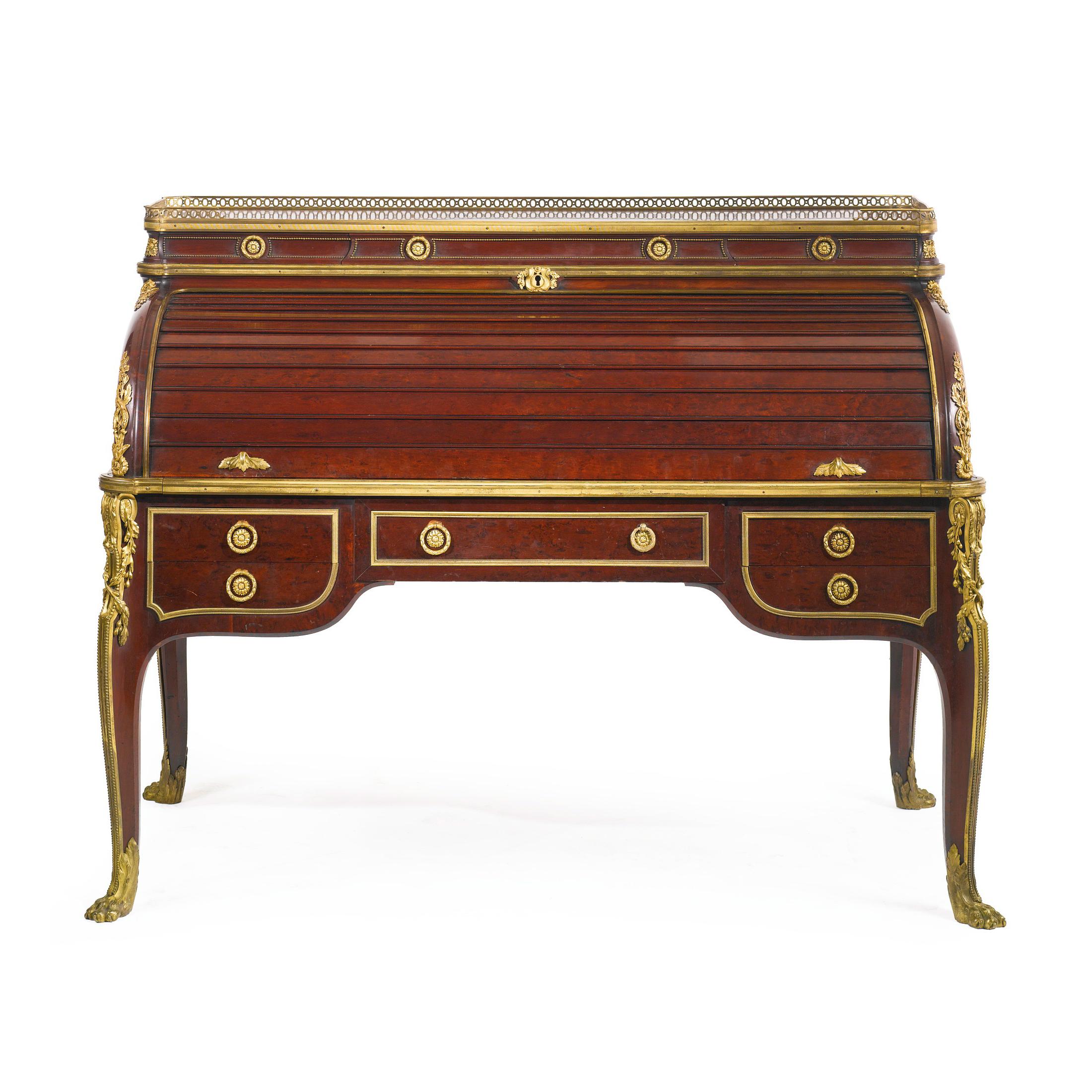 A fine quality Louis XVI style gilt bronze mounted plum pudding mahogany bureau à cylindre after the model by Jean-Henri Riesener.
The cylinder opening to six filing compartments and a blue leather lined writing slide, fitted with three small
