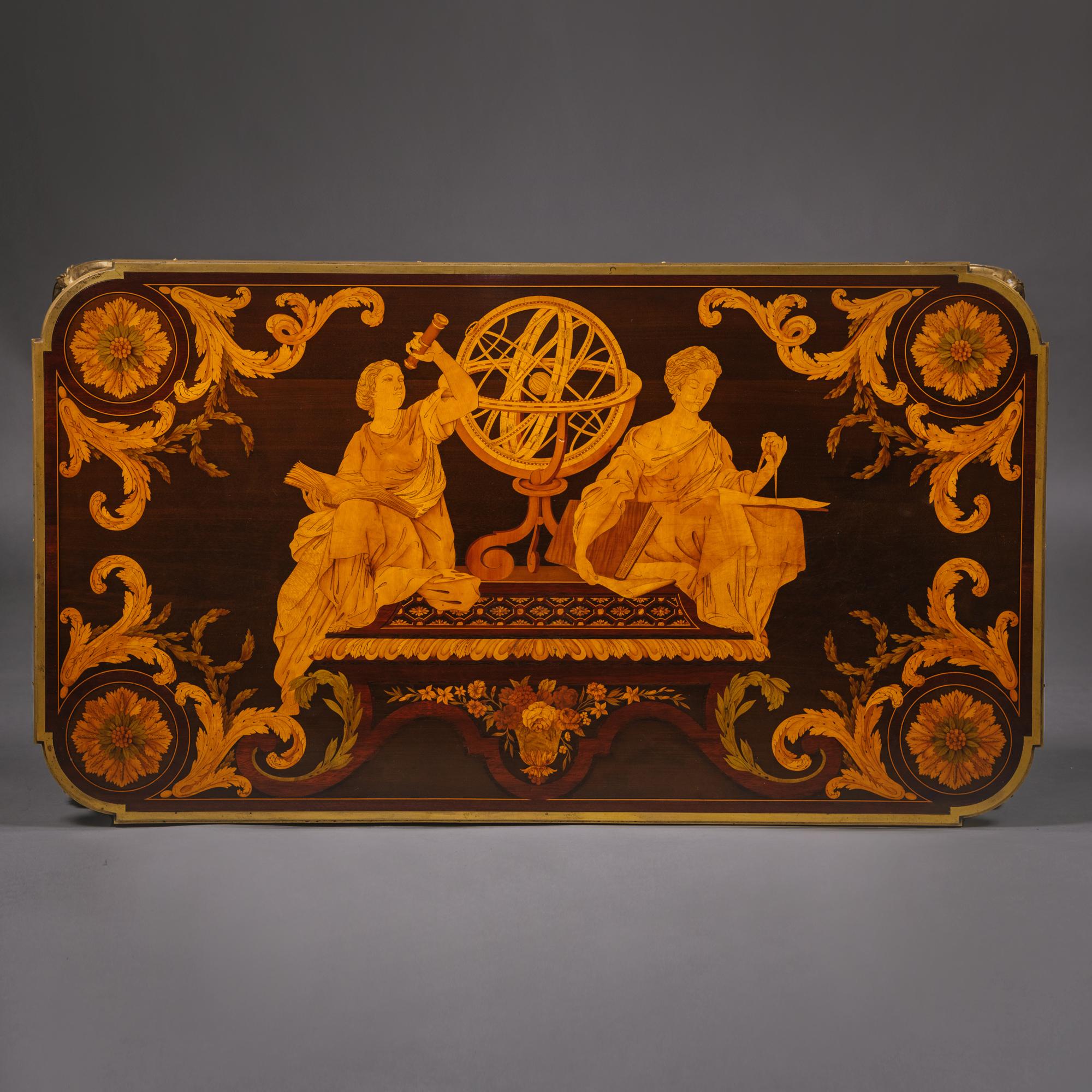 ‘Table des Muses’
A Louis XVI Style Gilt-Bronze Mounted Marquetry Centre Table 
By Emmanuel-Alfred (Dit Alfred II) Beurdeley, After The Model By Jean-Henri Riesener.

 Stamped ‘A BEURDELEY A PARIS’

The elaborate marquetry top depicts an