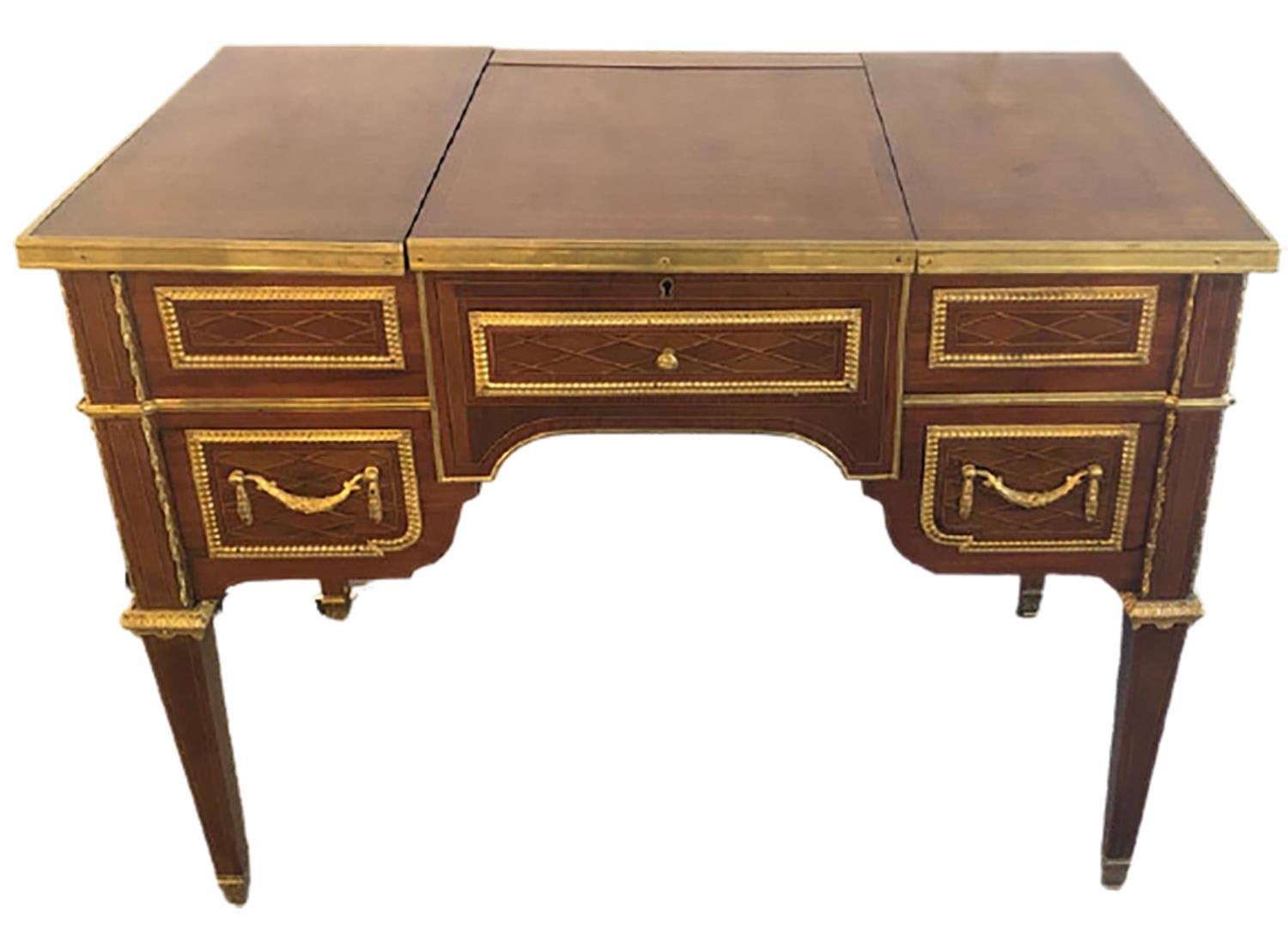 French 19th or early 20th century Louis XVI style gilt bronze mounted parquetry & marquetry dressing table, desk or vanity with interior flip up mirror. This stunning ladies desk or dressing table is certain to dazzle all. The finely gilt bronze
