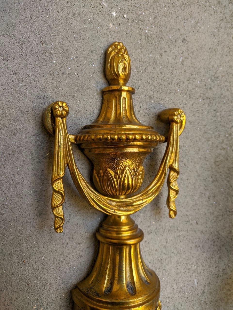 Louis XVI style gilt bronze three-light sconce with urn top and scroll arms. The vegetal decoration on the body and lower pine finial. Available in different finishings, colors and decorations.