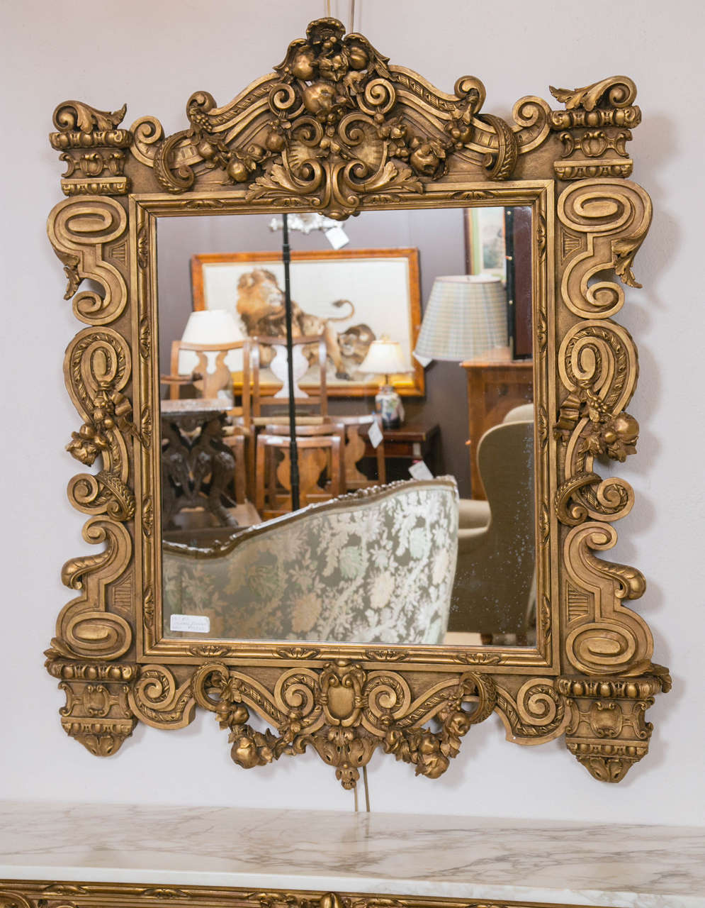 Finely carved and gilt decorated wall or console mirror this made in France Mirror is done in the Louis XVI Fashion having carvings of fruit and the like with scrolls decorating the whole. 
joy.

     