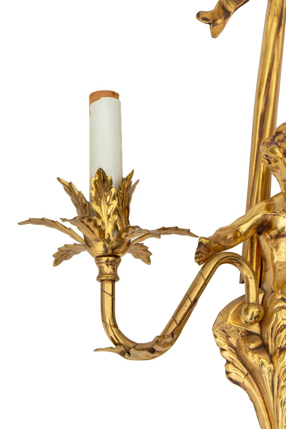 Pair of Louis XVI Style Gilt Metal Cherub Two Branch Wall Sconces, surmounted by ribbon bow motif. 22.5