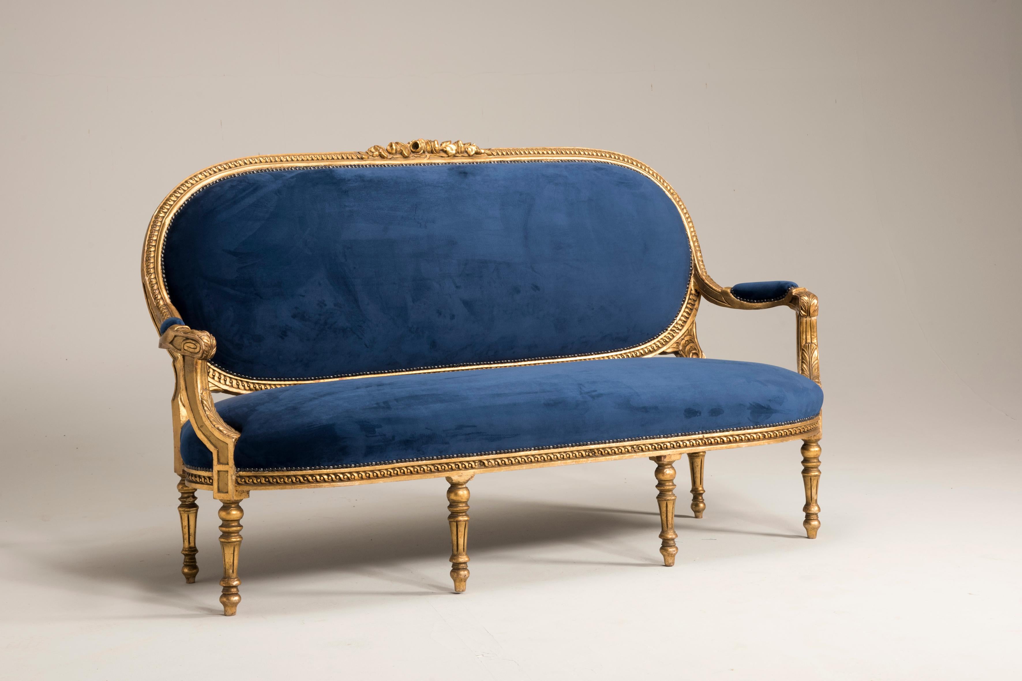 Louis XVI style giltwood goldfoil blue velvet sofa from Italy, from 1950. Conservative Restoration of wooden parts, re upholstered with blue velvet. 
Size: 
W 72.8346 inches / 185 cm
D 23.622 inches / 60 cm
H 41.7323 inches / 106 cm.

Feel free to