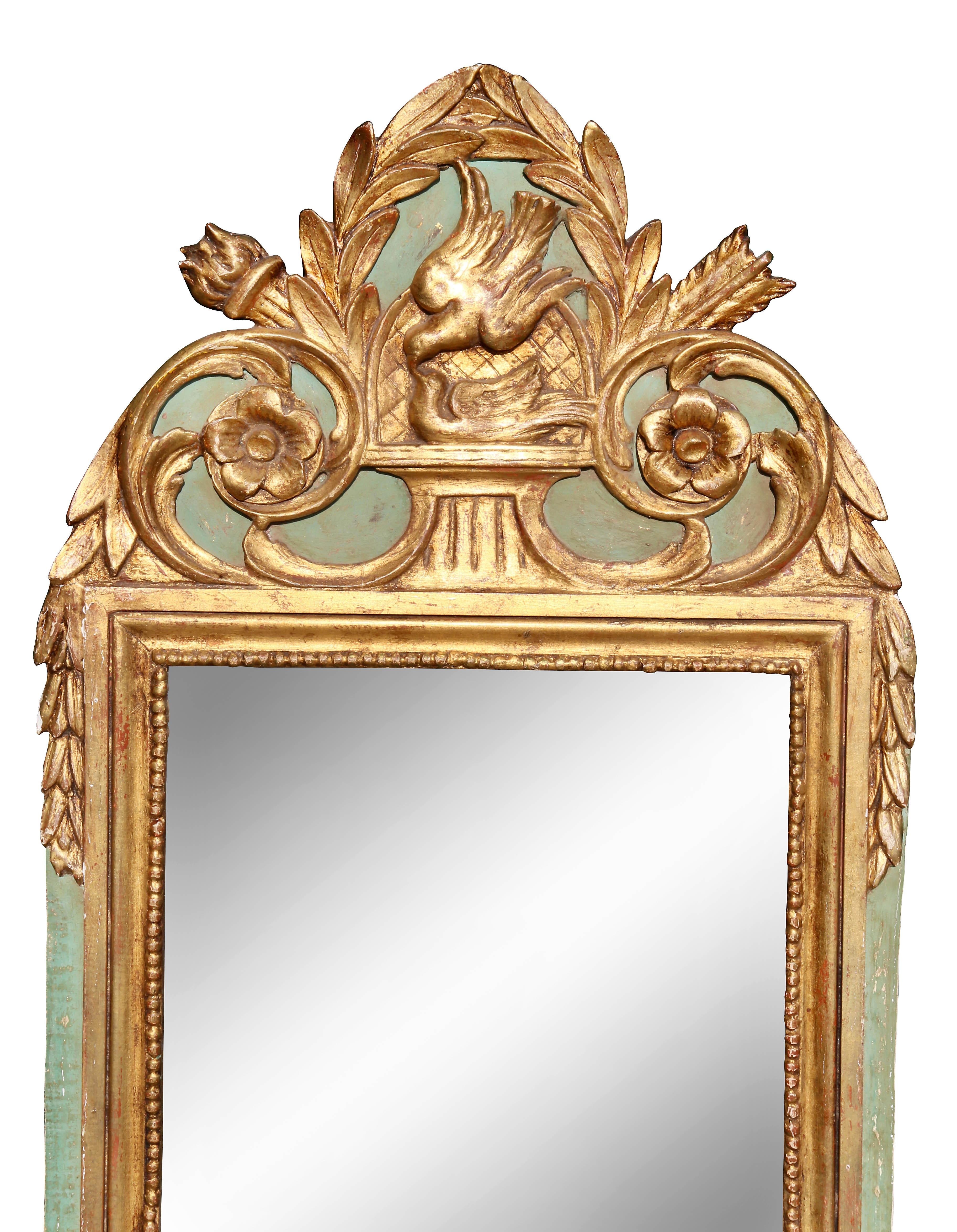 With laurel leaf with central bird crest over a mirror set in a conforming frame.