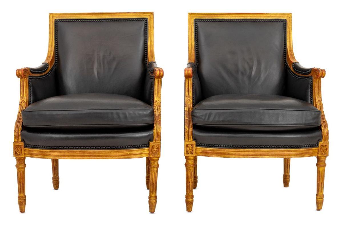Pair of Louis XVI Style Giltwood Black Leather Upholstered Bergeres, leather covered arm rests and carved scroll decoration on four fluted tapered legs. 37.25