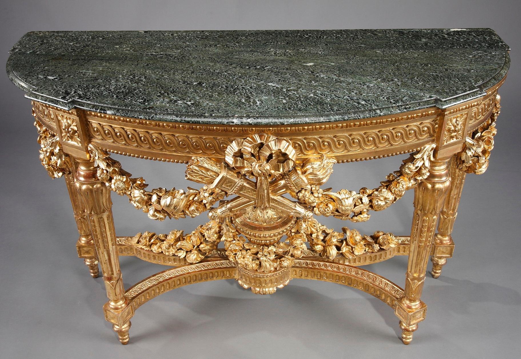 Fashioned in the Louis XVI style, this large refined giltwood console has an opulent decoration. Crafted of giltwood with a green vert-de-mer marble top, the half-moon table is lavishly bedecked with voluptuous garlands of flowers, antique vase,