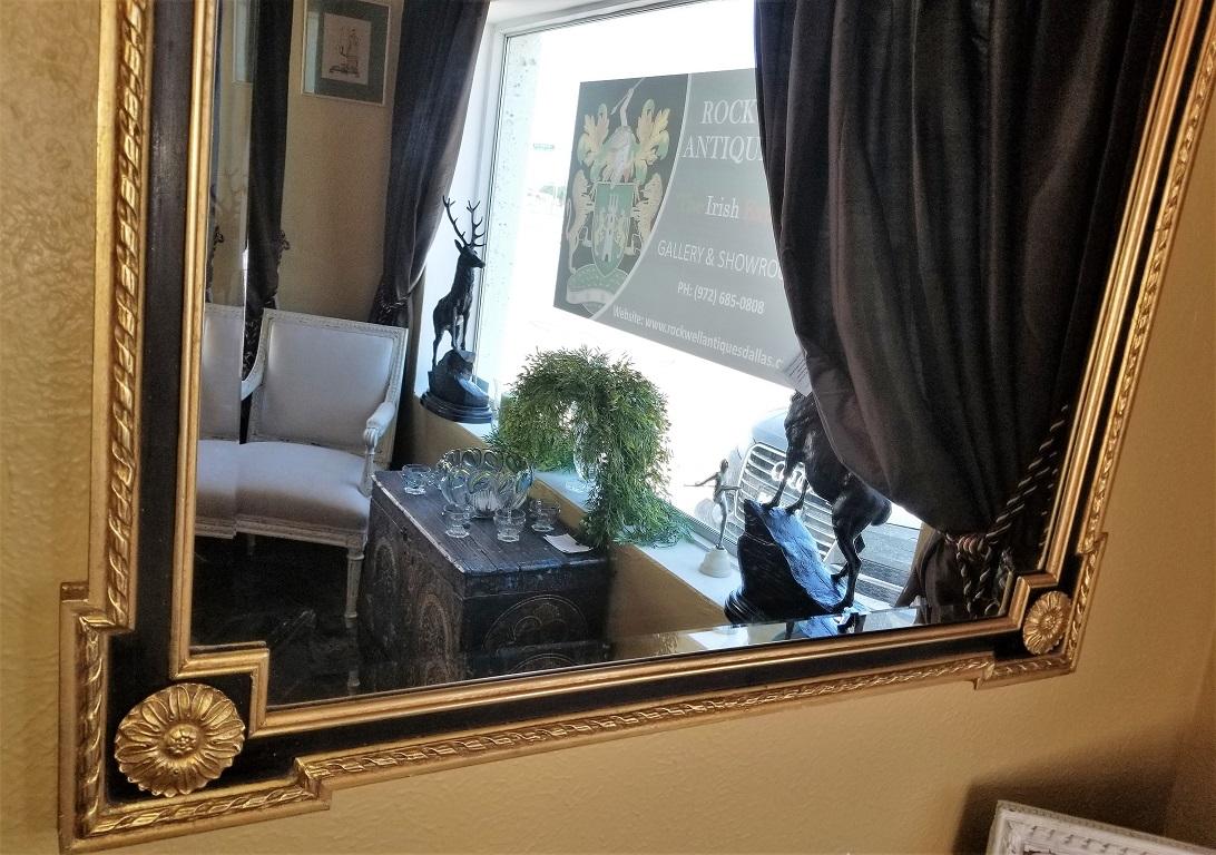 Presenting a lovely Louis XVI style giltwood and ebony beveled glass mirror.

Very nice size…. not too large but not too small.

Beautiful giltwood frame with classical floral wreath, sheaths, torches and bushells to the top.

Ebony colored