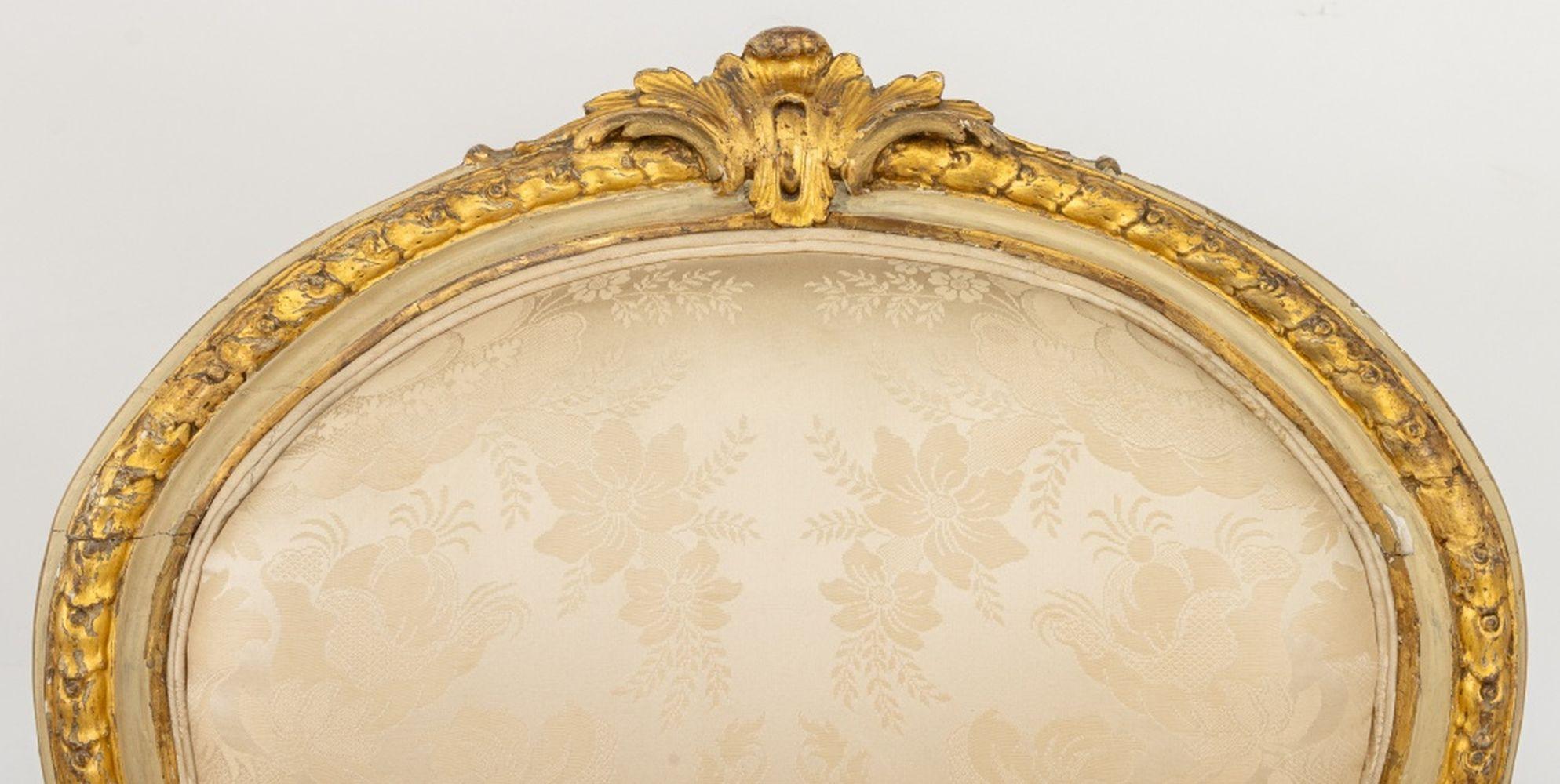 Louis XVI Style Giltwood Fauteuil, 19th century, upholstered in white damask silk, on four fluted tapered legs. 41