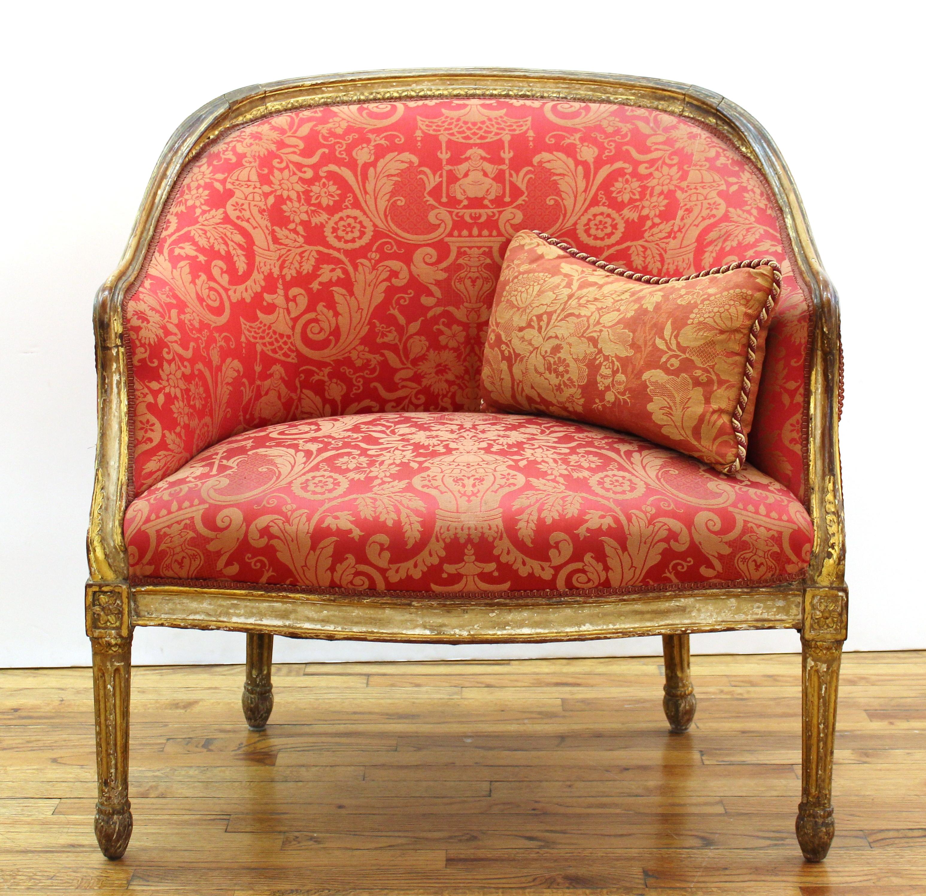 French Louis XVI style fauteuil with carved giltwood frame and damask upholstery, with small cushion.