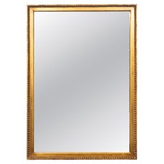 Miroir en bois doré de style Louis XVI
