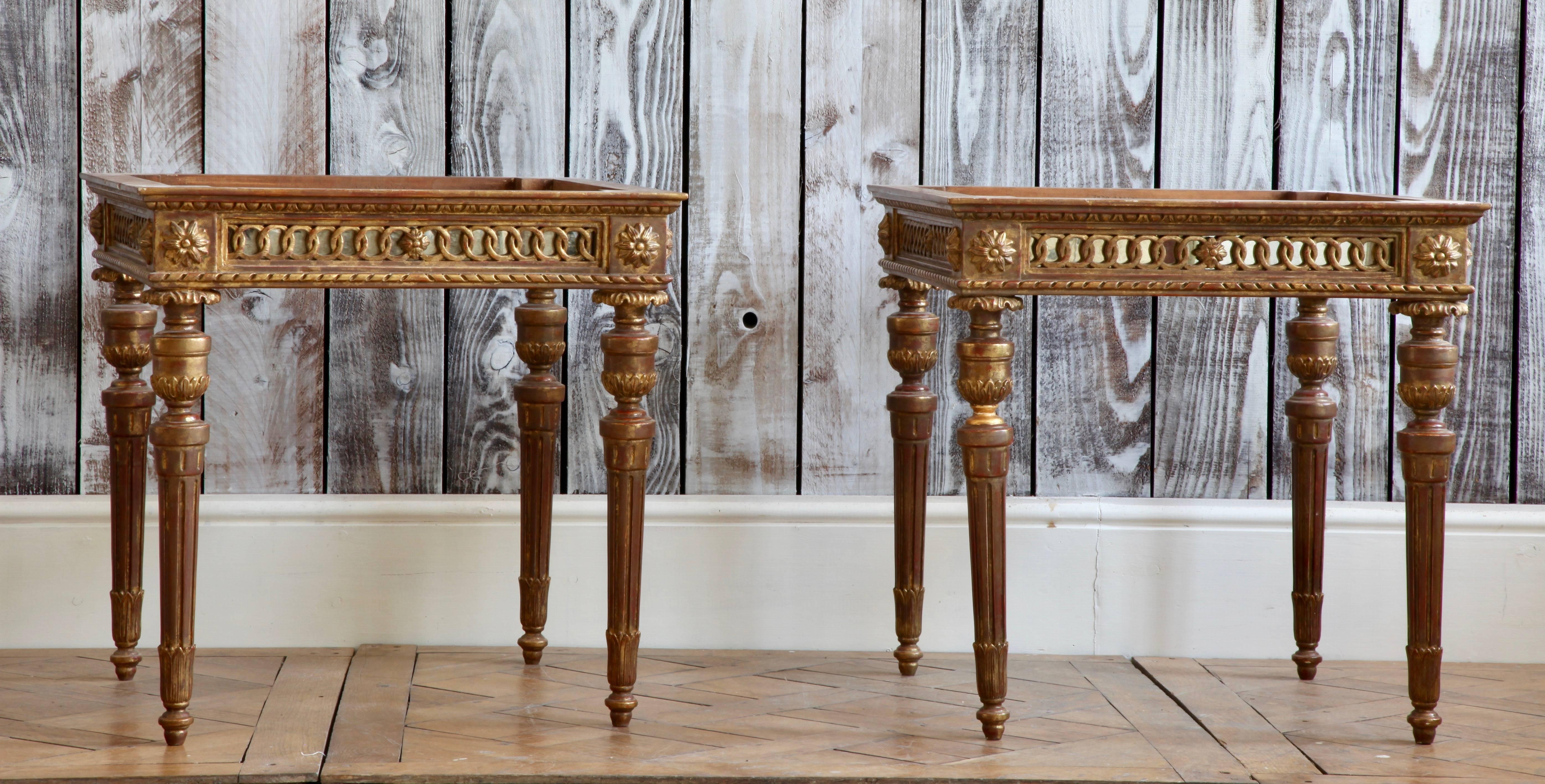 Louis XVI style giltwood coffee tables / side tables hand carved in solid wood.
Fine detailing with filigree worked backed with an antiqued mirror glass (Similar to the Venetian work found in the 18th century).
The tables have an aged gold
