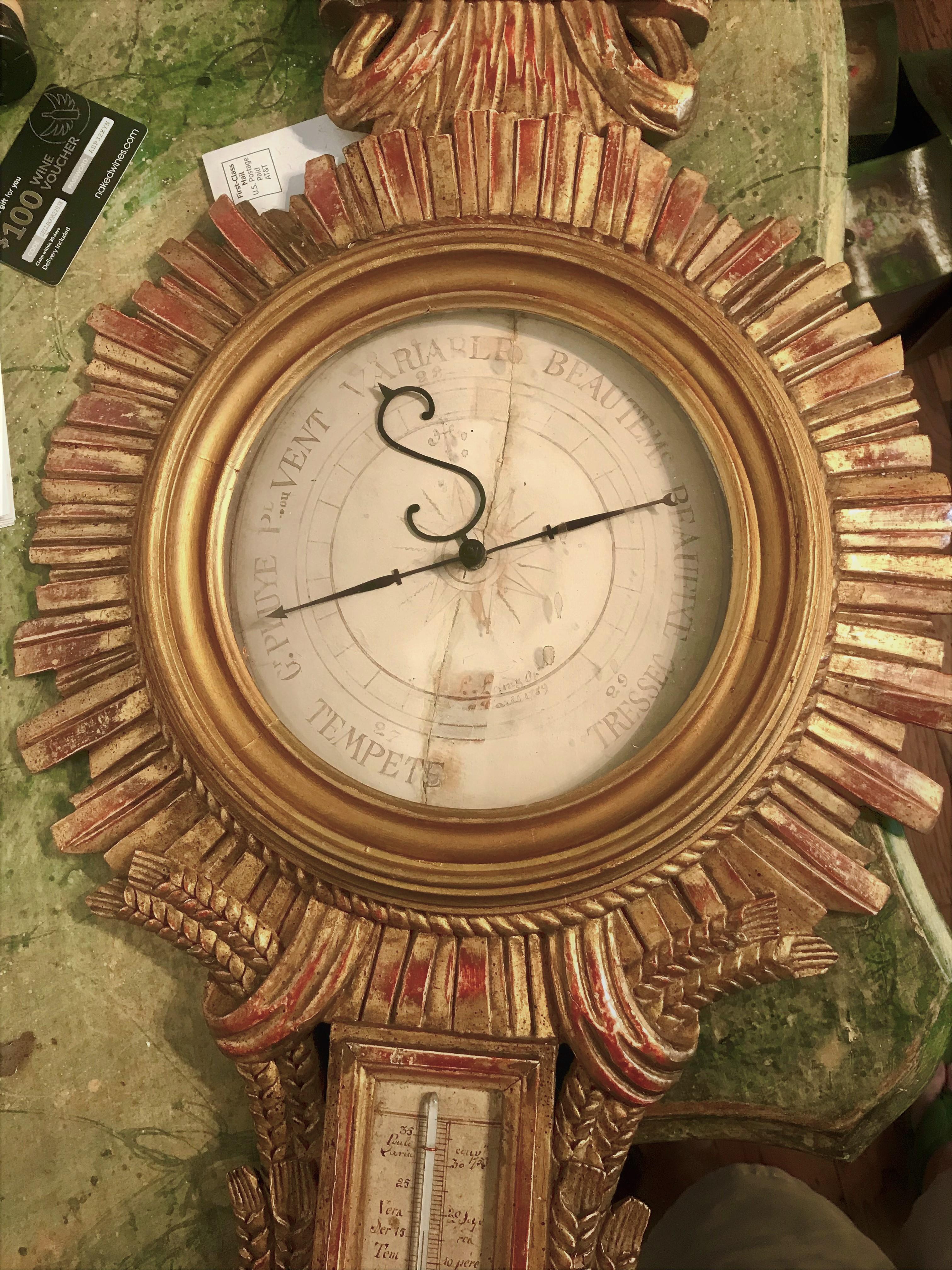 French gilt barometer case, early 1900's incorporating earlier 18th century parts. The center wood facing dated 1789 and encased by a rare or at least unusual carved sunburst .Presents very well with bleeding of red bole against the gilding . Highly