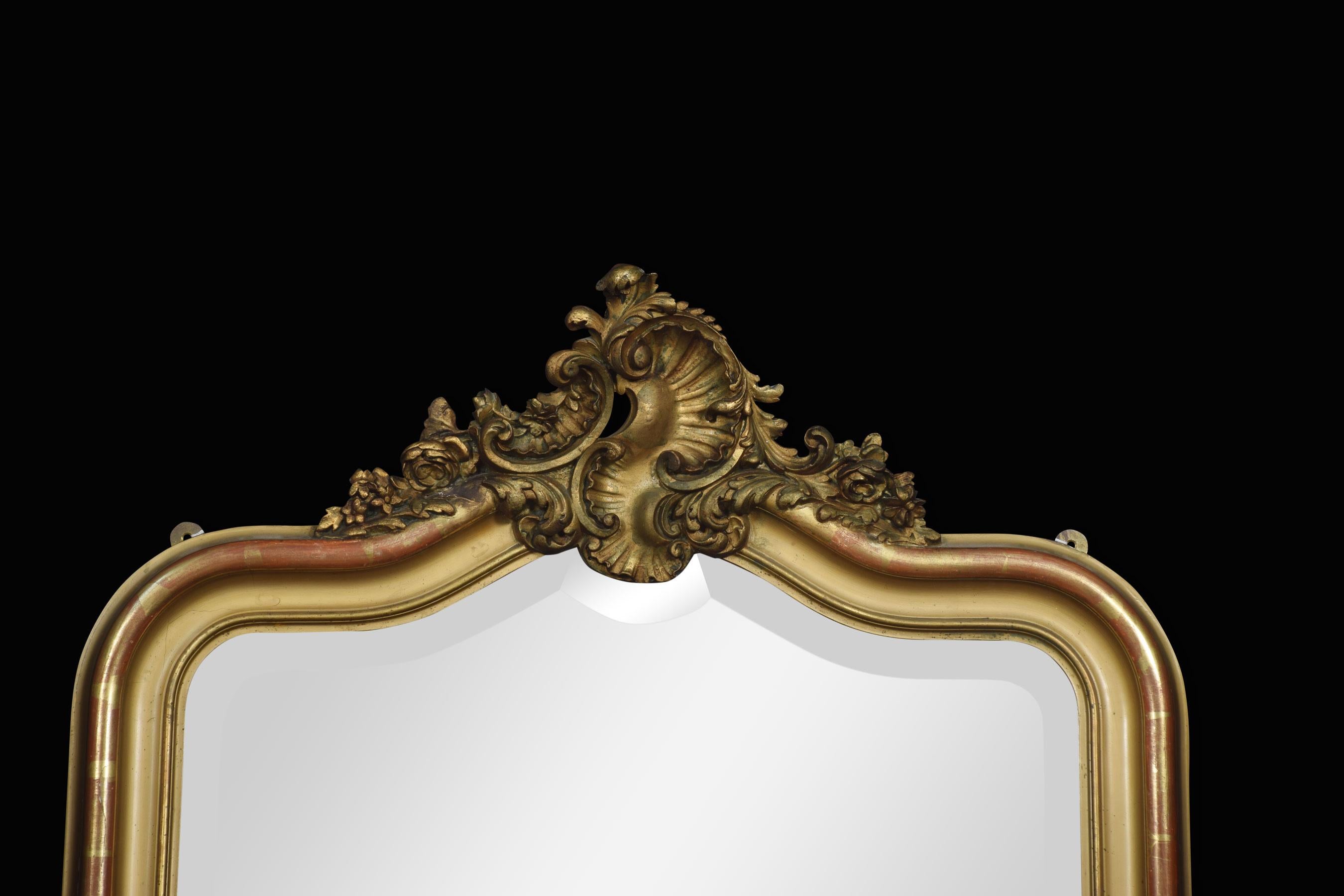 French Louis XVI style giltwood wall mirror, with gilt shell and scrolling foliate crest flanked by swept leafy spandrels, to the shaped original beveled mirrored plate within a molded frame.
Dimensions
Height 51 inches
Width 36 inches
Depth 3
