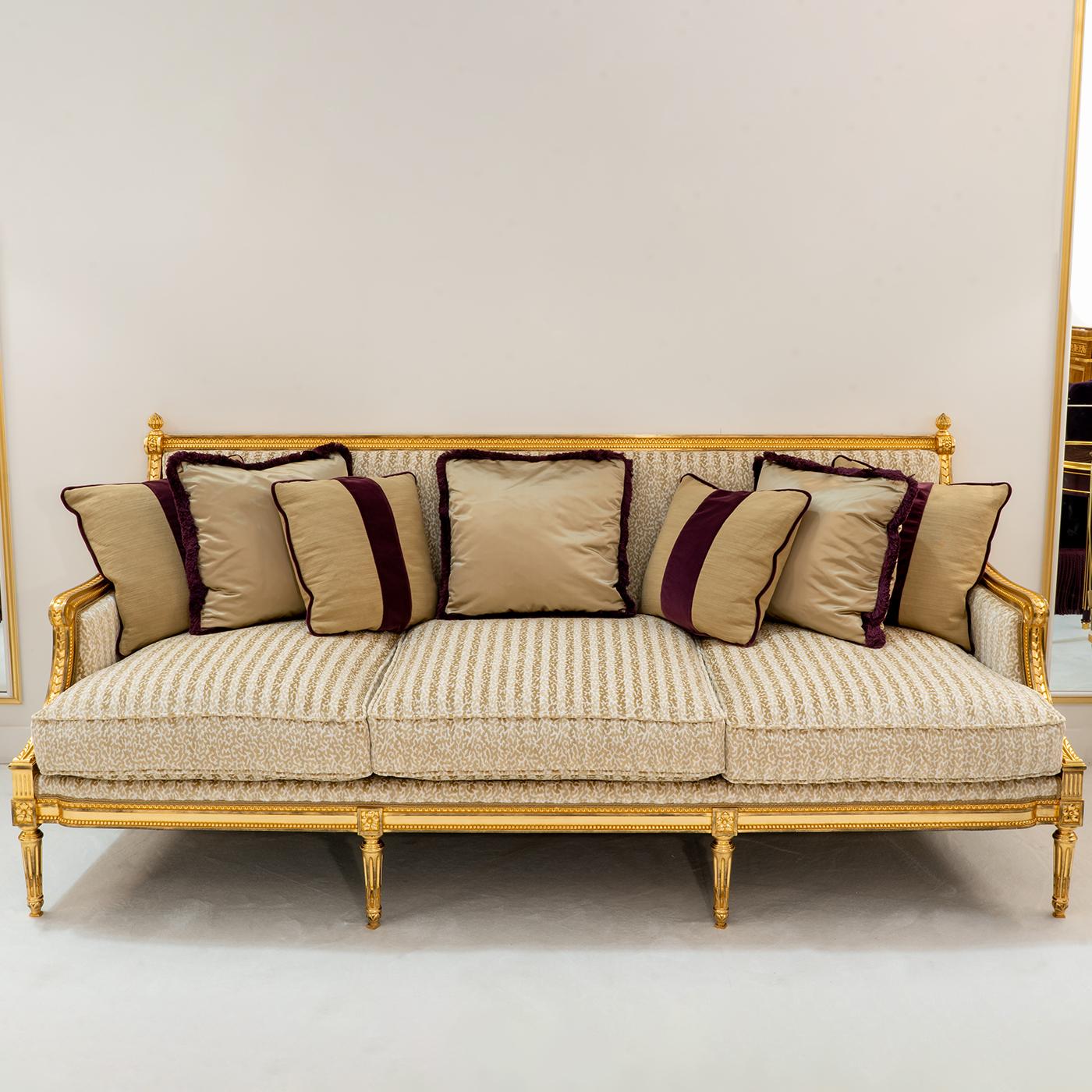 This luxurious sofa recalls seating in Royal European courts. Covered in gold leaf, the frame sports minute detailing obtained as a result of a meticulous hand-carving process that implies the uniqueness of every single piece. A sophisticated
