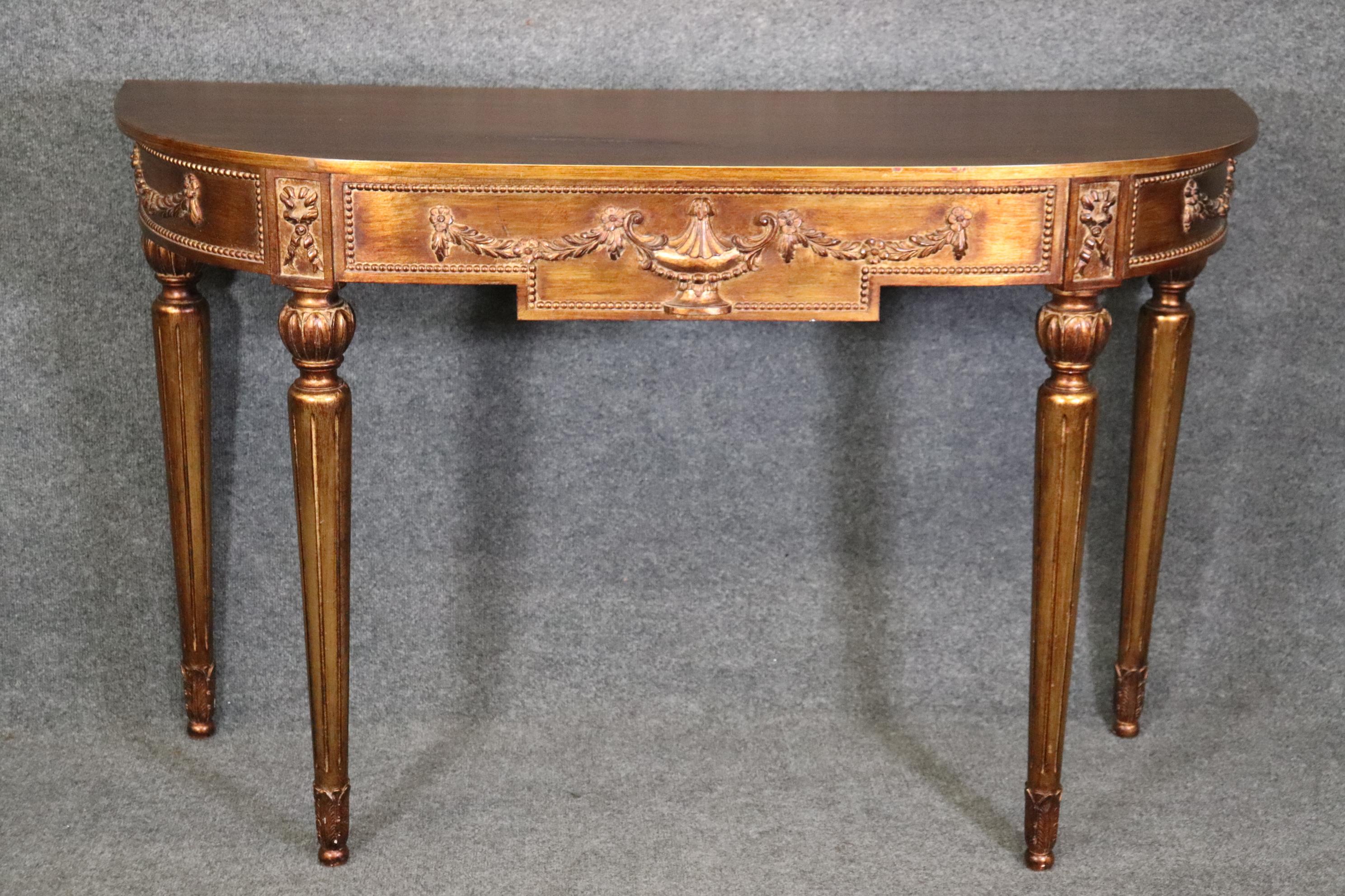Dimensions- H: 34 3/4in W: 54in D: 18 1/2in 
This Louis XVI Style Gold Gilt Demilune Console Table is a perfect addition to your home or place of choosing and will certainly bring a sense of luxury along with it! This piece is equipped with a