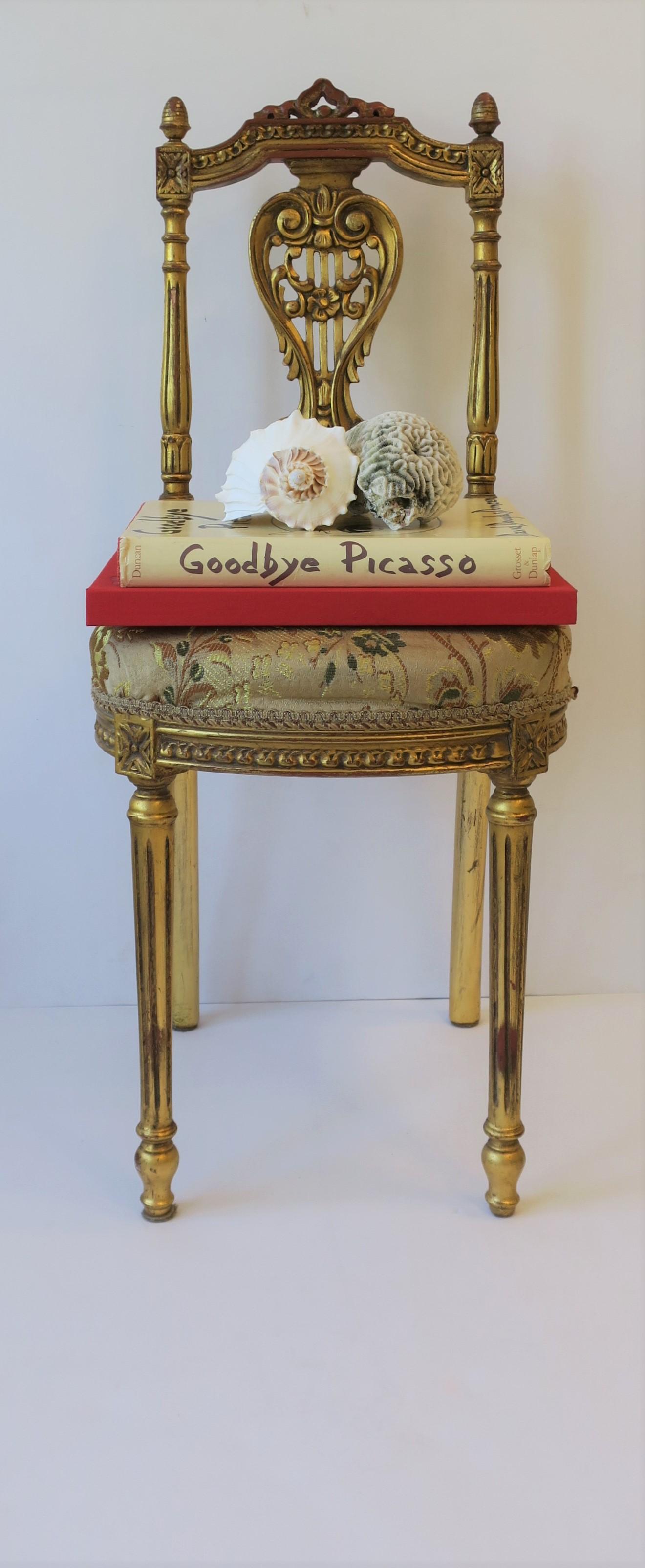 A beautiful vintage gold giltwood upholstered side or desk chair in the Louis XVI style, circa 20th century, Europe. Chair is a convenient size; a great option for a vanity, bathroom, dressing or closet area, etc. 

