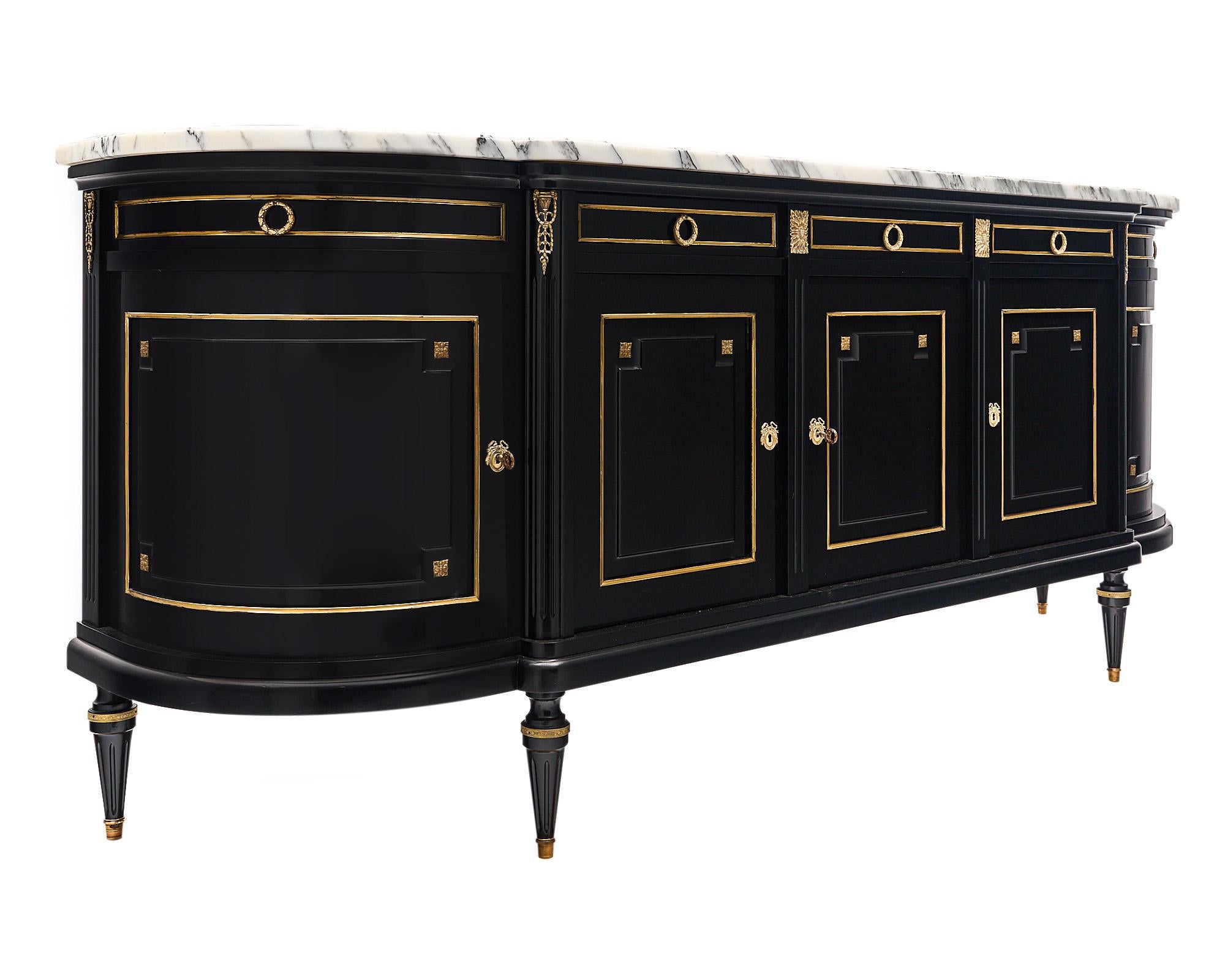Buffet / enfilade from France made of solid mahogany that has been finished in a museum-quality French polish for a lustrous effect. There are five doors that open to interior shelving below five dovetailed drawers. The ends have curved drawers and
