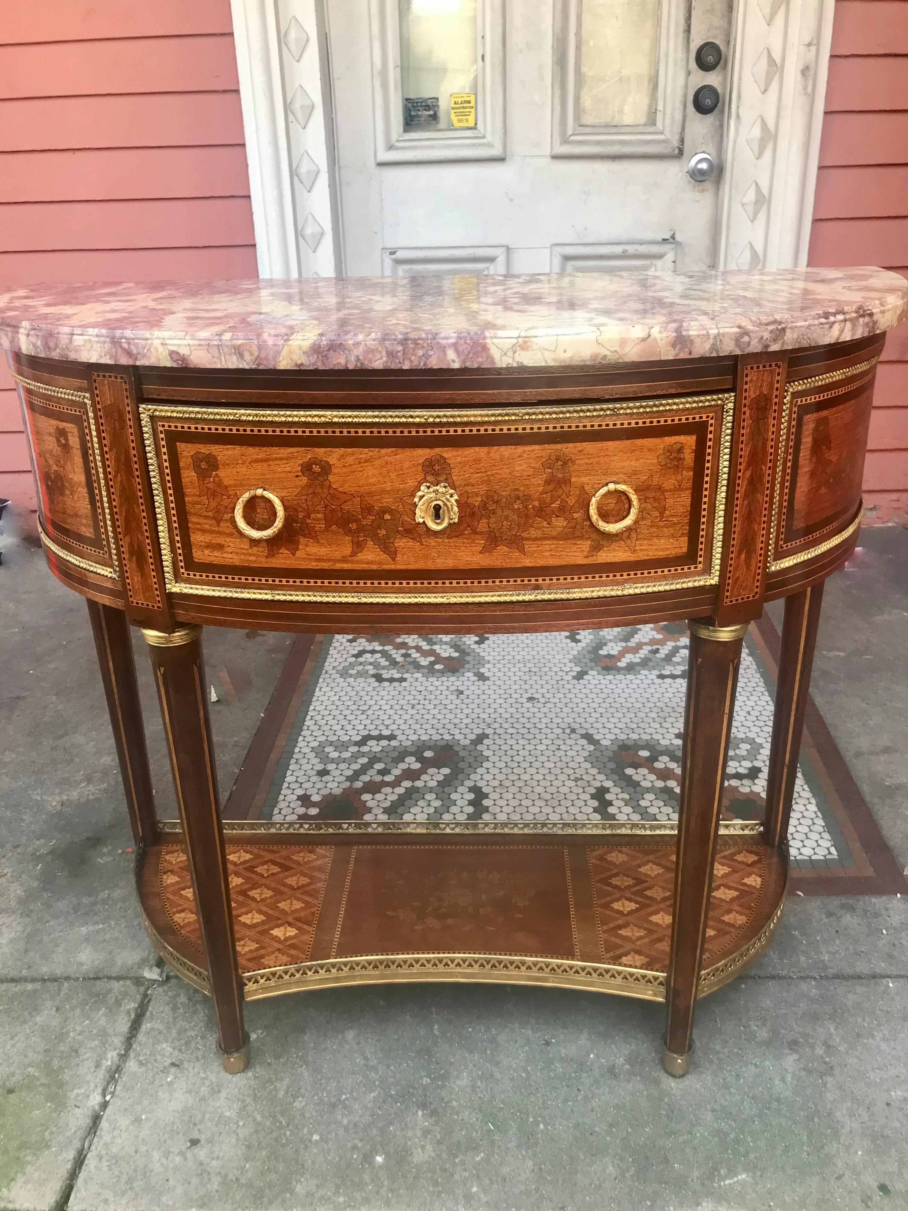 trimmed in gilt metal mounts . Very pretty and presents very well . The top skirt stenciled with floral garlands across three panels , the 4 leg stiles with downward festoons. The legs inlaid with spears. the bottom stretcher with central floral