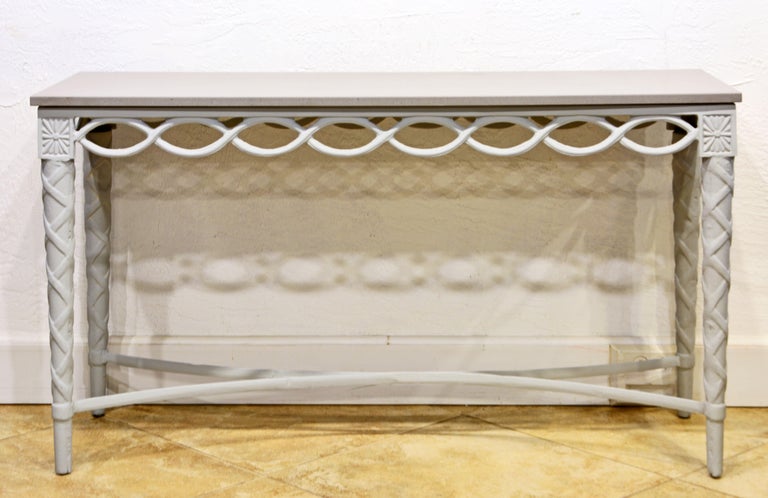 Handmade in cast aluminum this charming console tale is designed in a style reminiscent of the Louis XVI style. It is painted light gray and has a custom made gray stone top. Since aluminum is not prone to rust the table can be used indoors as well
