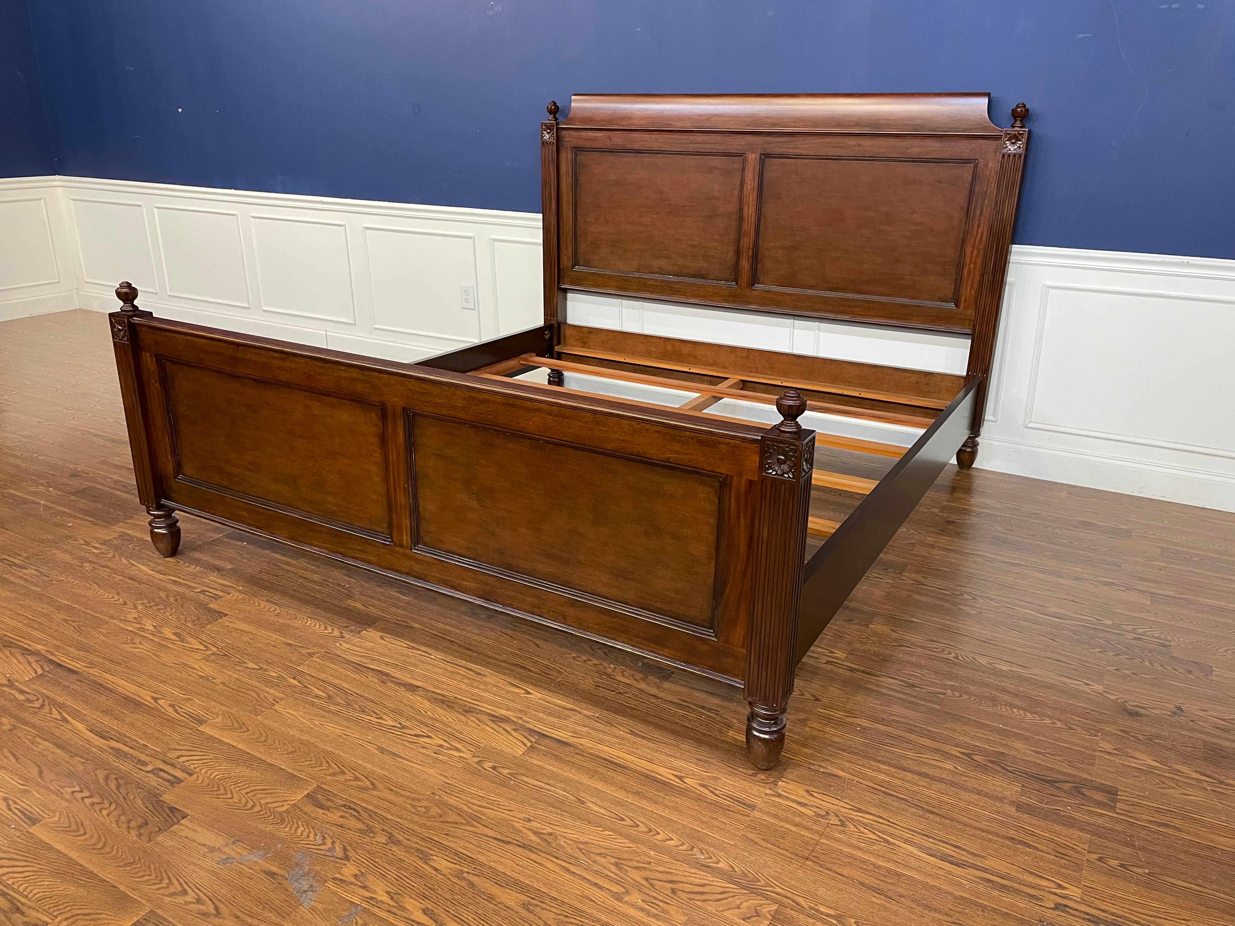 This is a Louis XVI style king size mahogany bed by Leighton Hall.  It has classic Louis XVI styling with fluted posts and finials and a paneled headboard and paneled footboard.  
Dimensions:
Length: 88.5”
Width: 82.25”
Headboard Height: