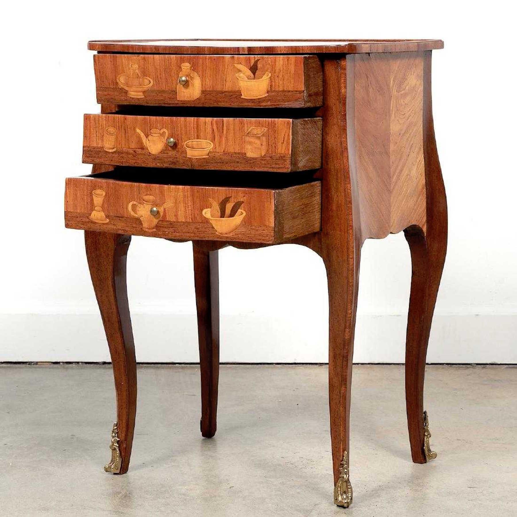 Louis XVI style king and tulip wood marquetry end table, fitted with three drawers with exotic woods marquetry inlay.



