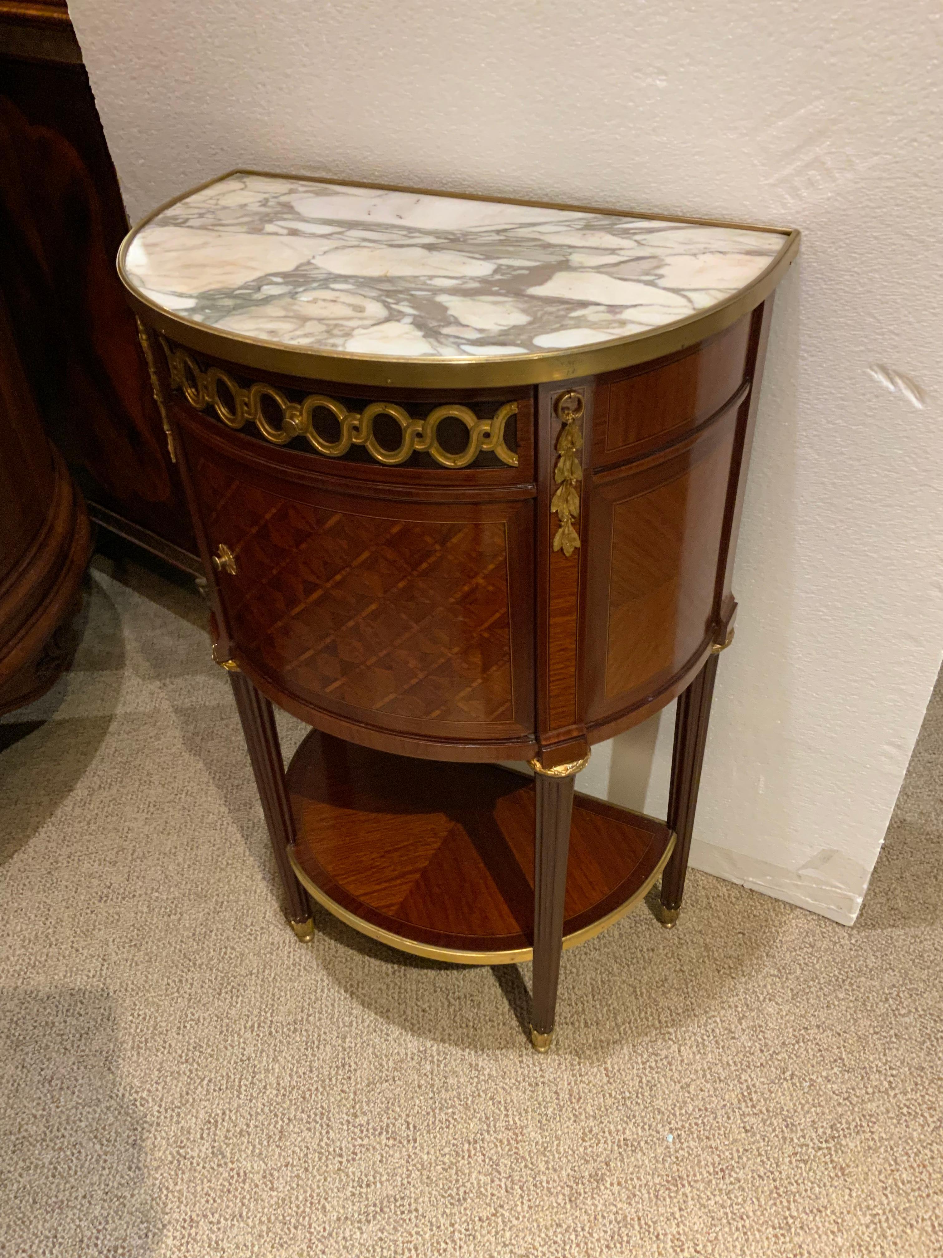 This is a signed French cabinet by the maker “Krieger” which makes
This piece special. It is signed at the top of the drawer. The marble top
Is in shades of cream and beige with taupe hues. The marble is bound
In a brass. The case is in a