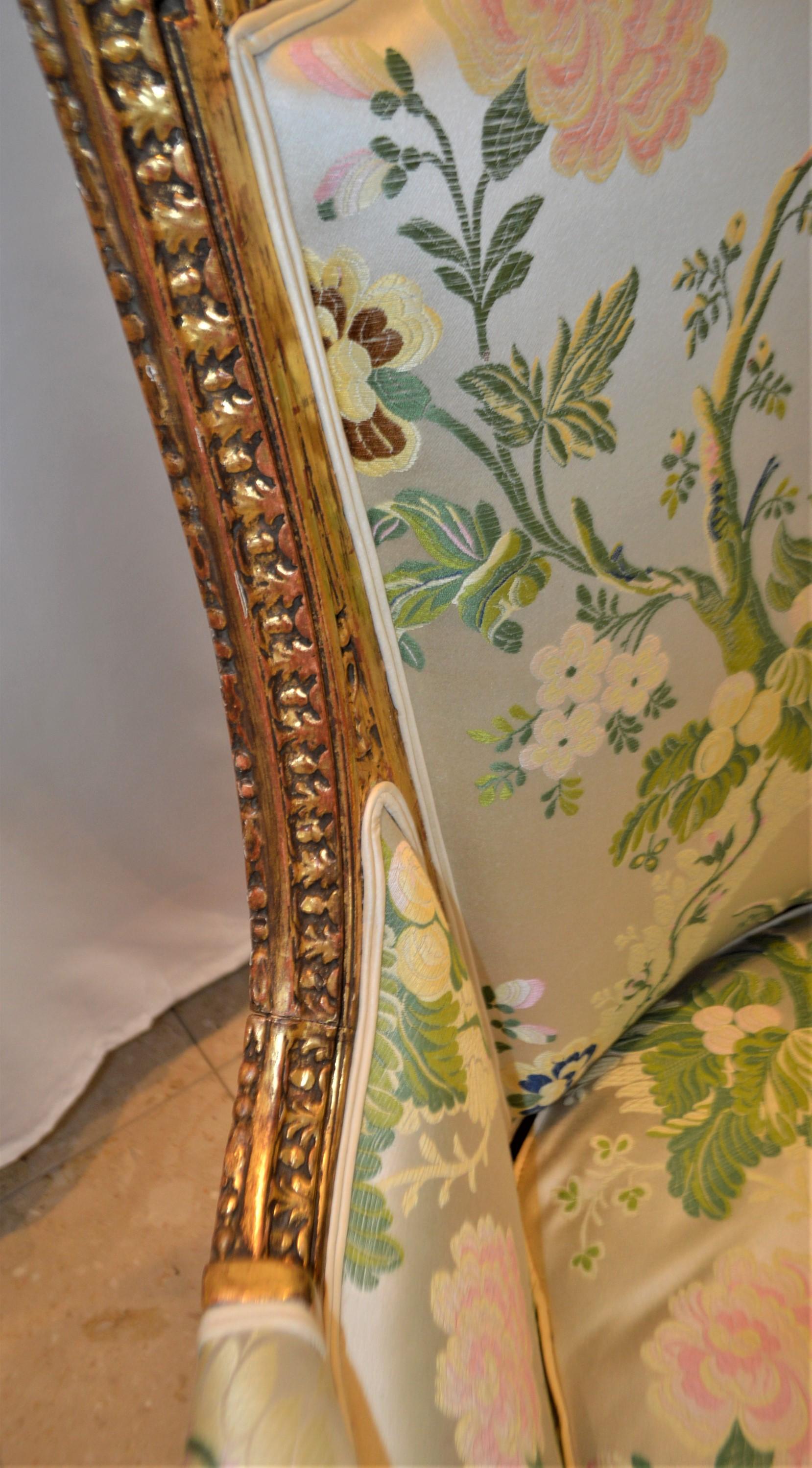 Louis XVI style leaf gilded bergere chair, hand carved, silk botanical fabric. In Good Condition In Oakville, ON
