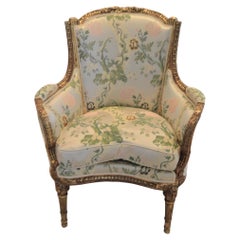Louis XVI style leaf gilded bergere chair, hand carved, silk botanical fabric.