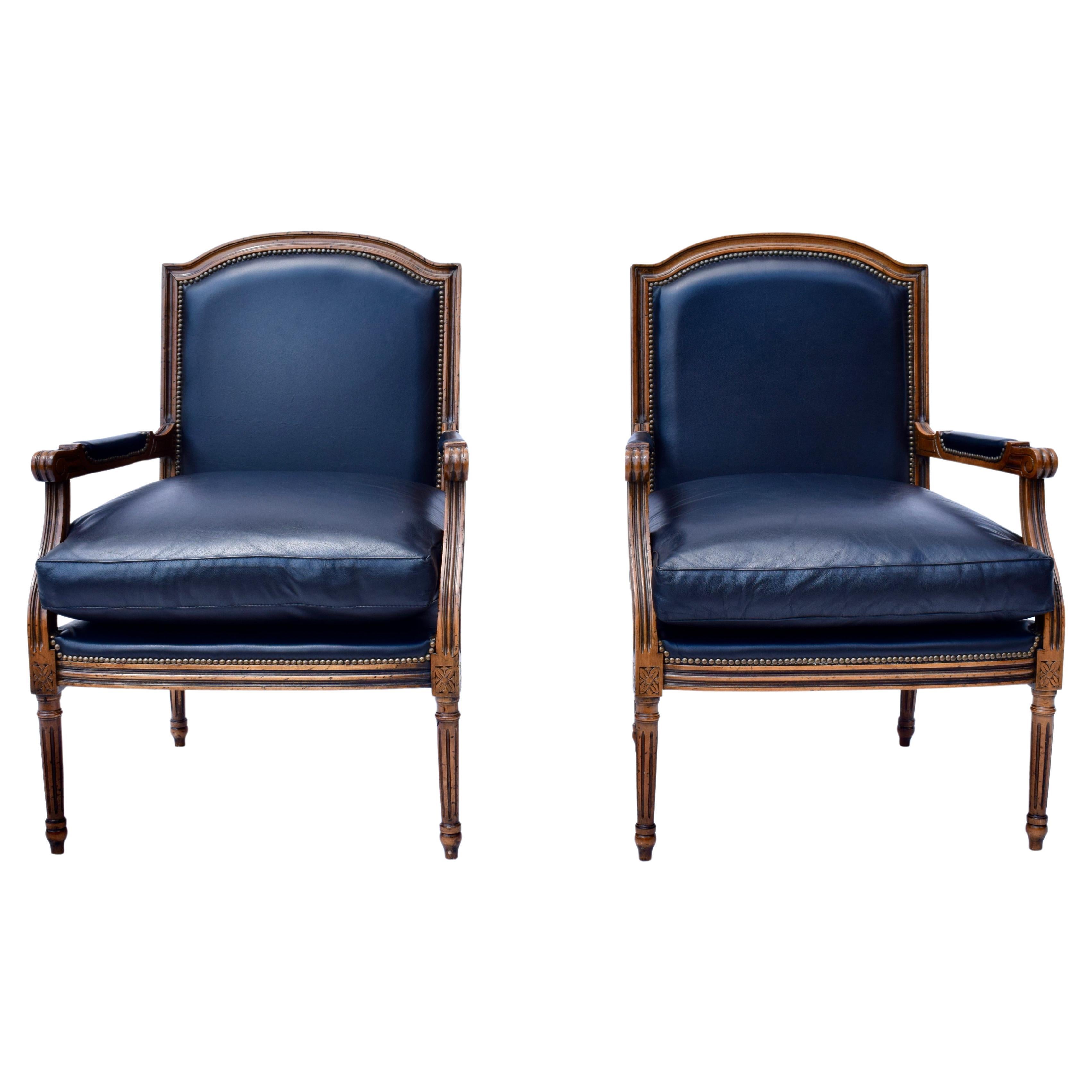 A pair of late 20th Century Louis xvi style plush leather Fauteuils  with carved walnut frames & brass tack detailing. Excellent vintage condition; rarely if ever used.. Seat Height: 20