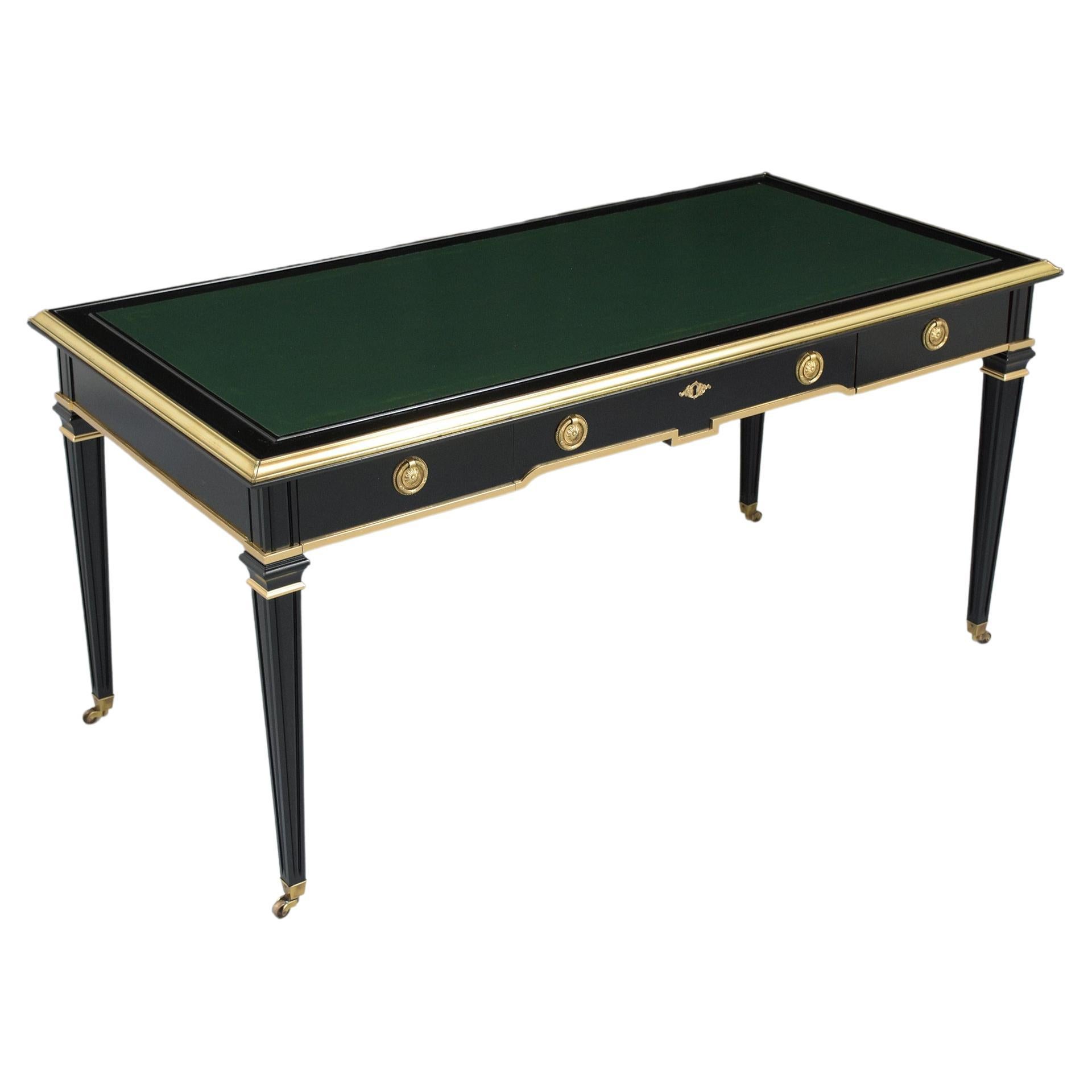 This extraordinary 1950s Louis XVI style leather desk is in great condition beautifully crafted out of mahogany wood and has been professionally restored by our expert craftsmen team. This desk is eye-catching and features an elegant ebonized