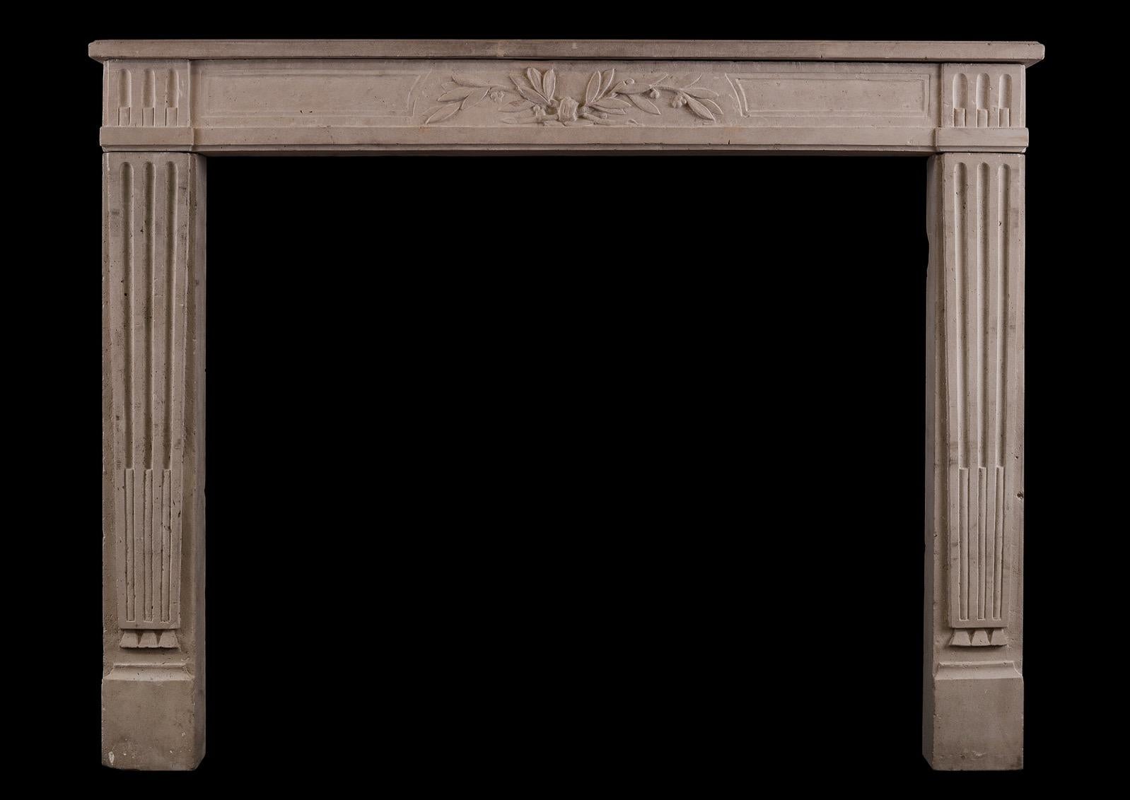 A 19th century French Louis XVI style stone fireplace. The stop-fluted jambs surmounted by carved frieze featuring tied leaves. Moulded shelf above.

Shelf Width:	1335 mm      	52 1/2 in
Overall Height:	1055 mm      	41 1/2 in
Opening Height:	900 mm