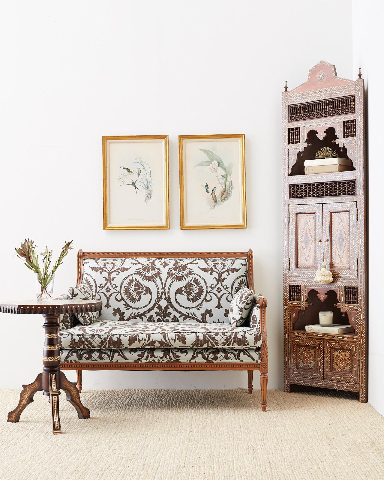 Fantastic French Louis XVI neoclassical style settee or canape featuring a recent modern upholstery redux with a Fortuny style print in linen. The entire frame is upholstered and has a loose seat cushion with two throw pillows. The beautifully