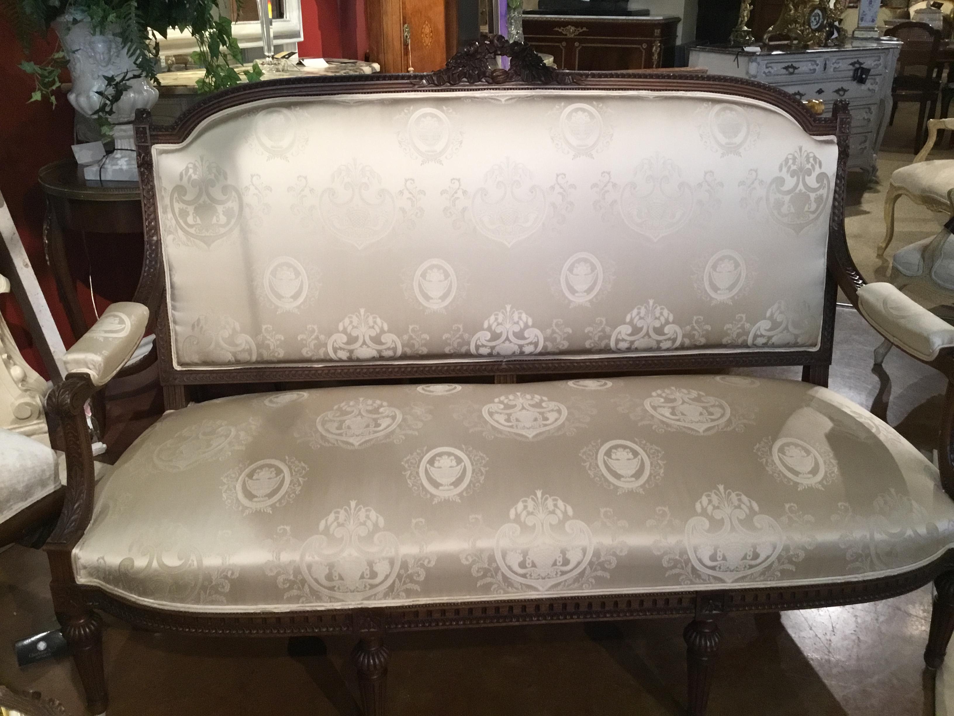 Beautiful five piece living room suite, Louis XVI style made in walnut with
A carved wreath of roses at the crest of the sofa and all of the chairs.
All are newly upholstered in white silk damask fabric. Reed and tapered
Legs. All pieces are