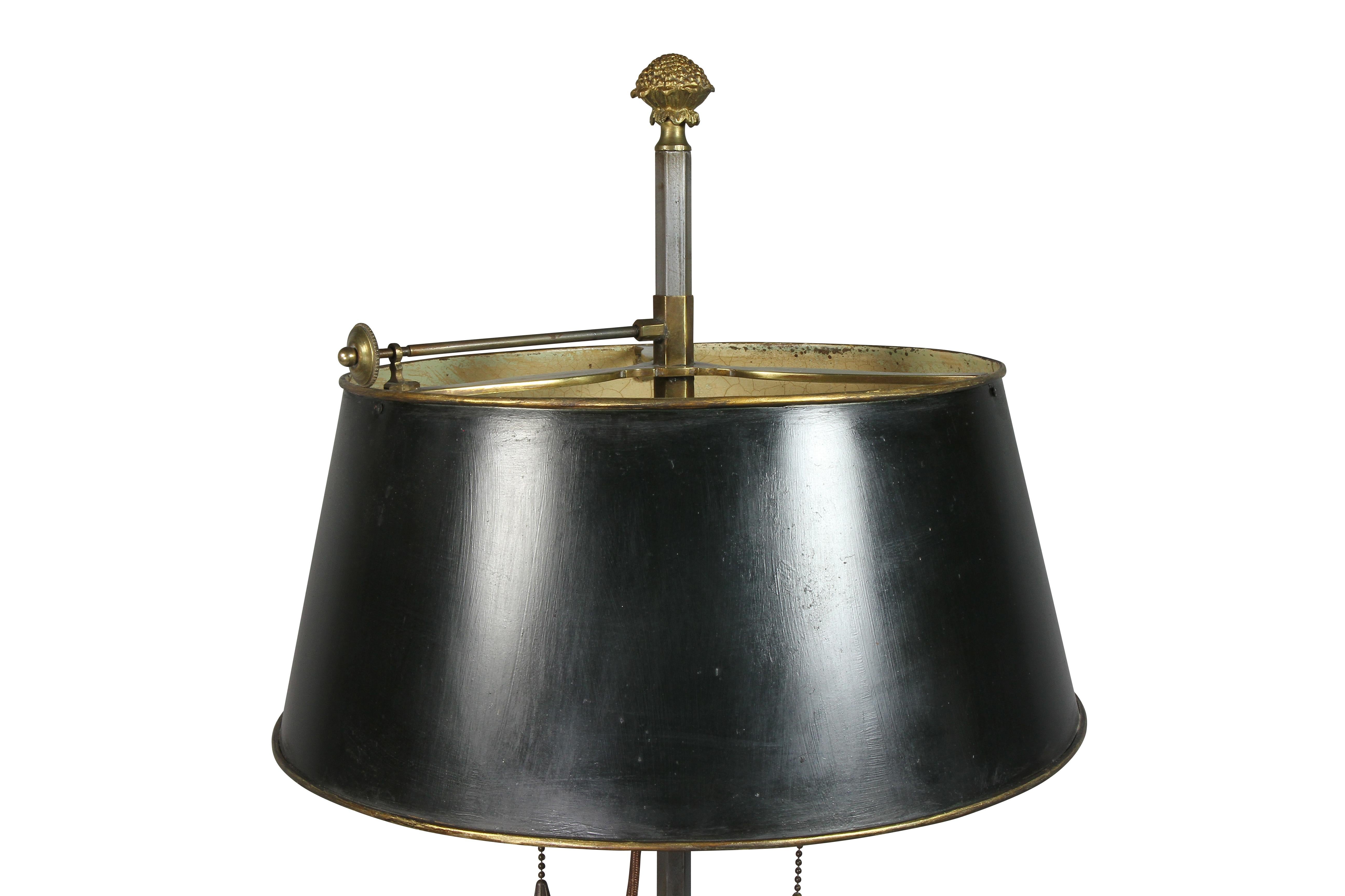 With green adjustable conical shade and gilt bronze finial, two light, and three lower candleholders, circular mahogany and brass base.