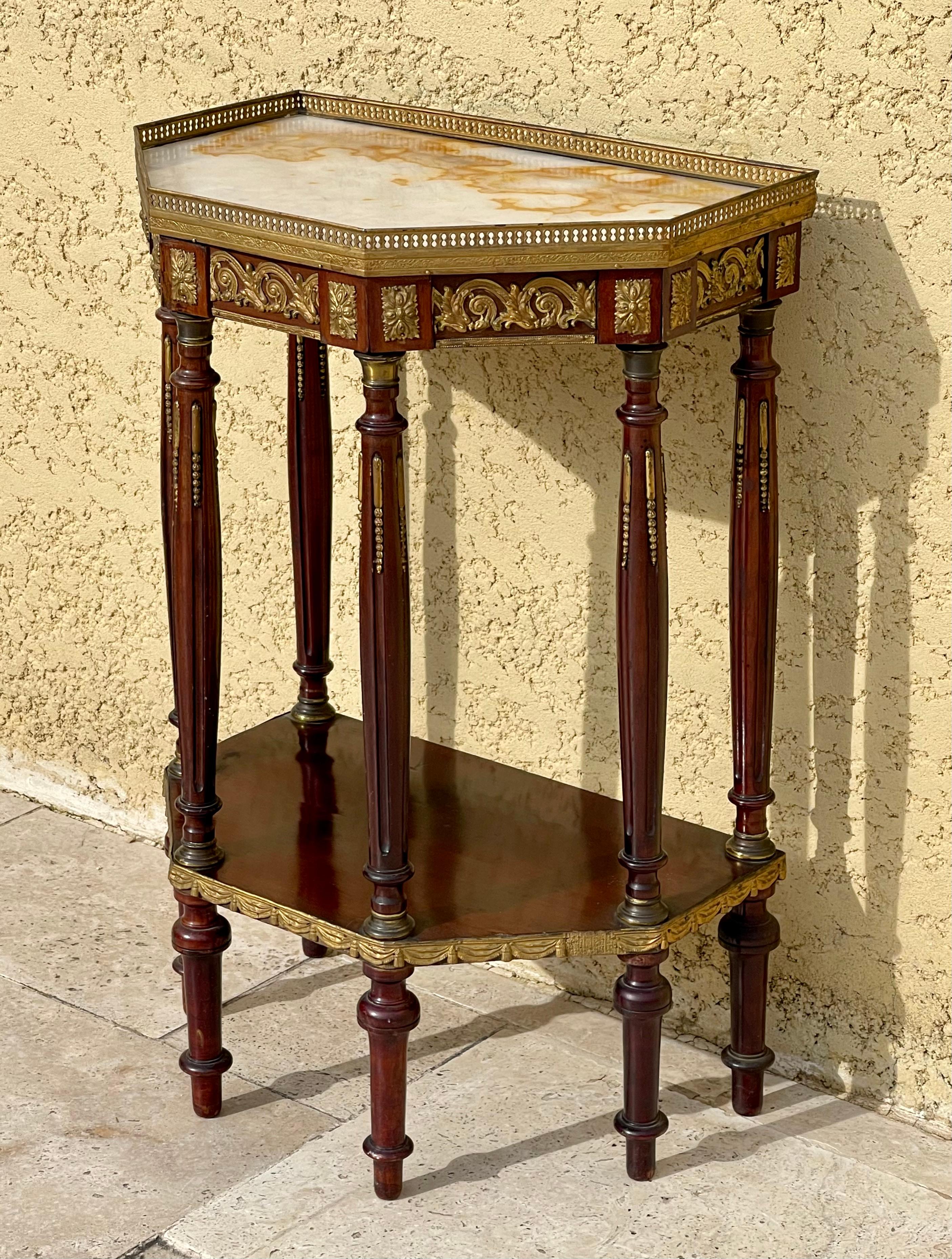 Louis XVI / Napoleon III style mahogany stand with 6 legs. White marble top with small bronze gallery. It is in good condition.

Dimensions
Width 48.5cm
Depth 32cm
Height 74.5cm