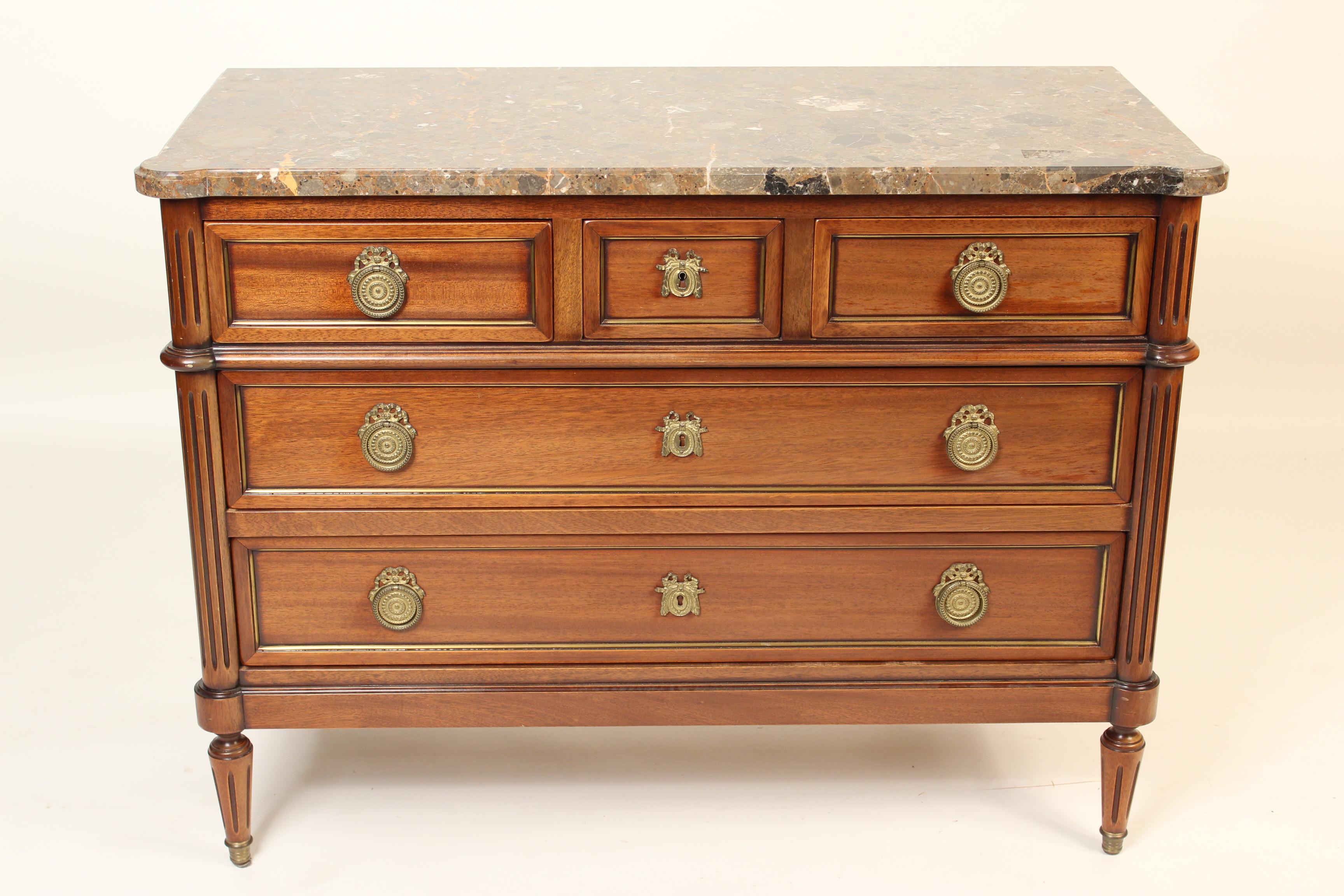 Louis XVI style mahogany chest of drawers with marble top and brass moldings on drawer fronts, circa 1980s.