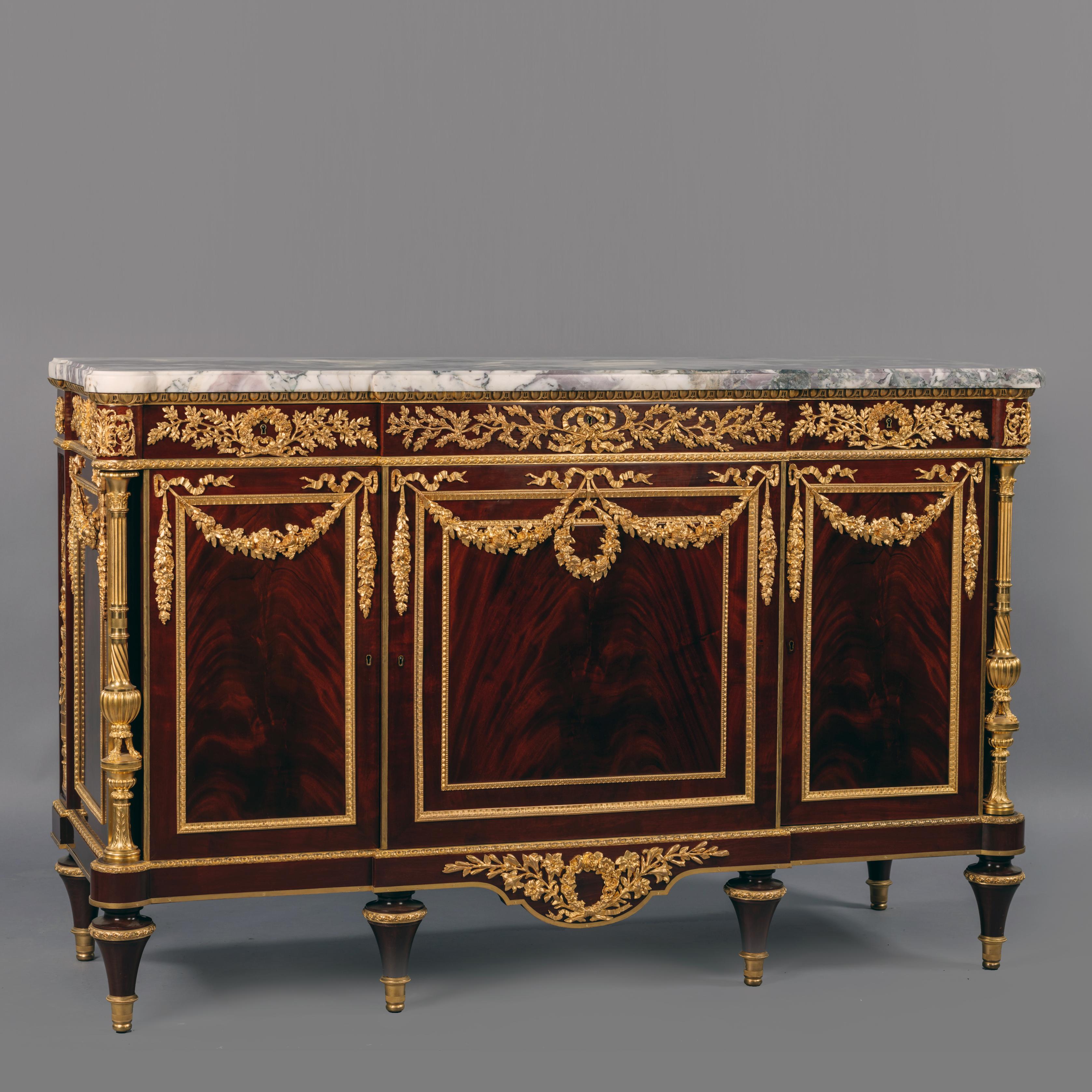 A fine Louis XVI style gilt bronze mounted mahogany commode, in the manner of Martin Carlin, attributed to Henry Dasson.

The lockplate signed to the reverse 'Duvivier, Paris'. 

The design for this elegant commode is taken from the celebrated
