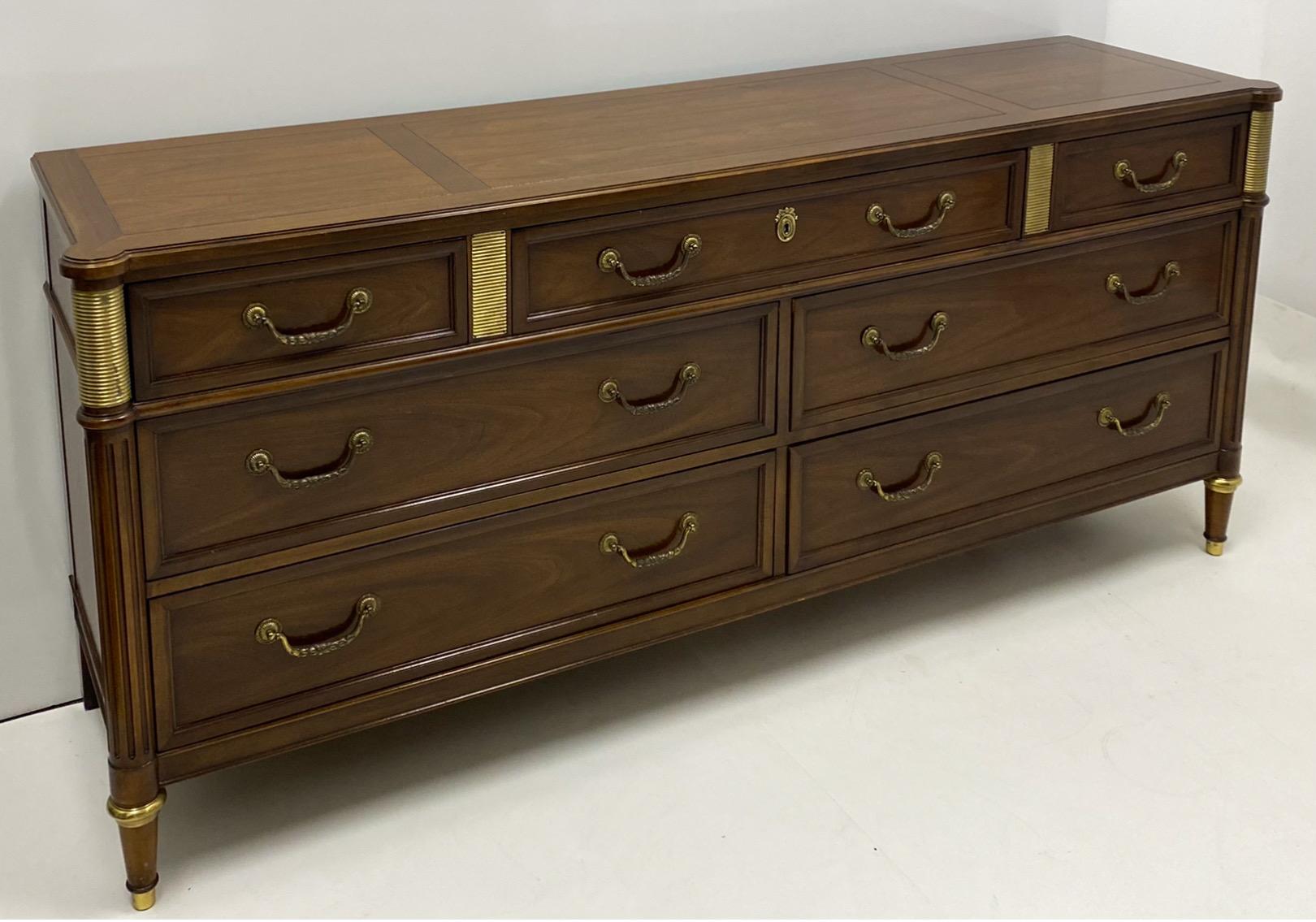 This is a lovely Louis XVI style mahogany commode or long chest of drawers by Baker Furniture. It is marked and in very good condition. The piece dates to the 1970s.
