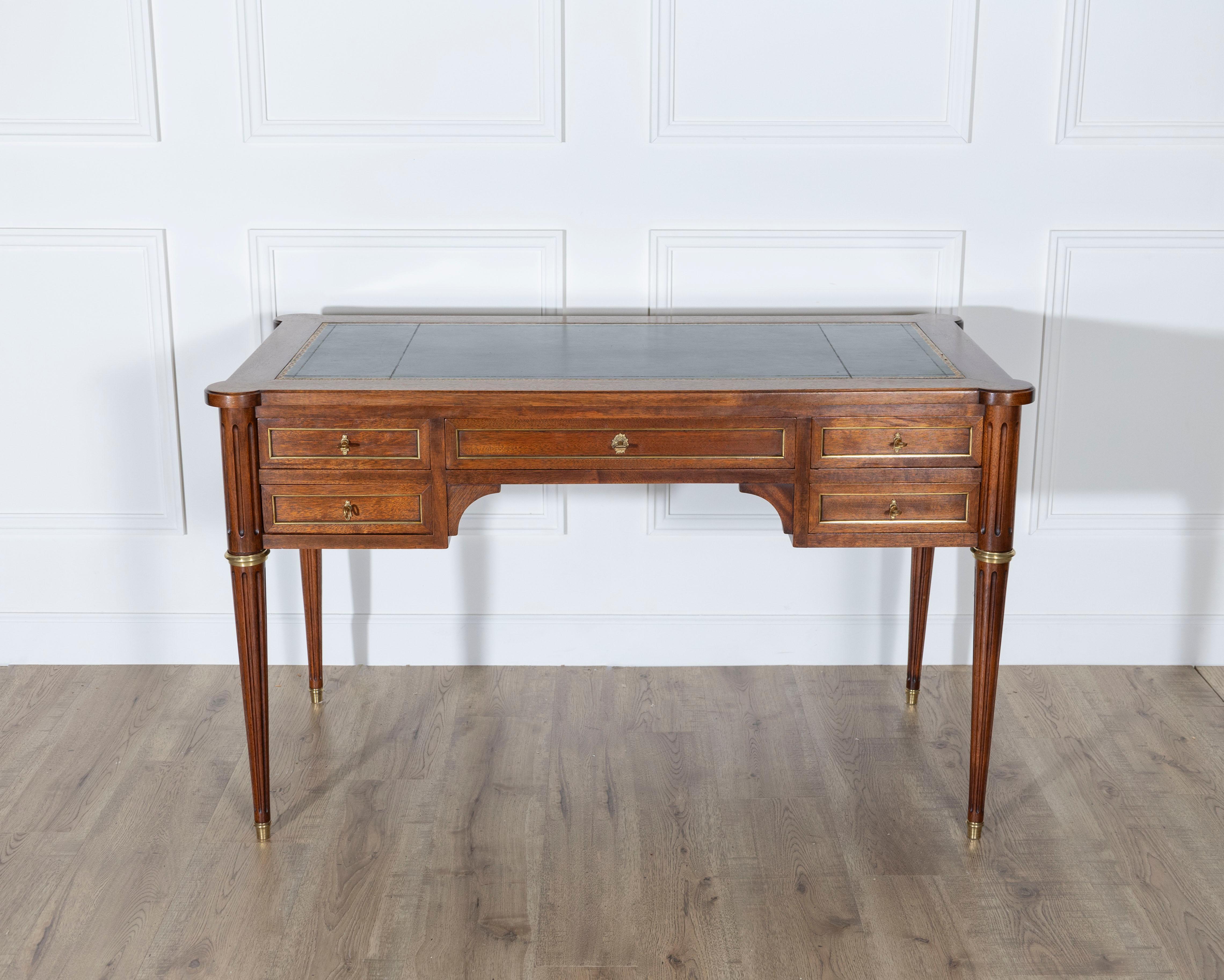 An elegant Louis XVI style flat desk in mahogany, double-sided and beautifully proportioned, featuring classic neoclassical details and refined craftsmanship. The desk opens at the front with five drawers, each fitted with a functional lock and