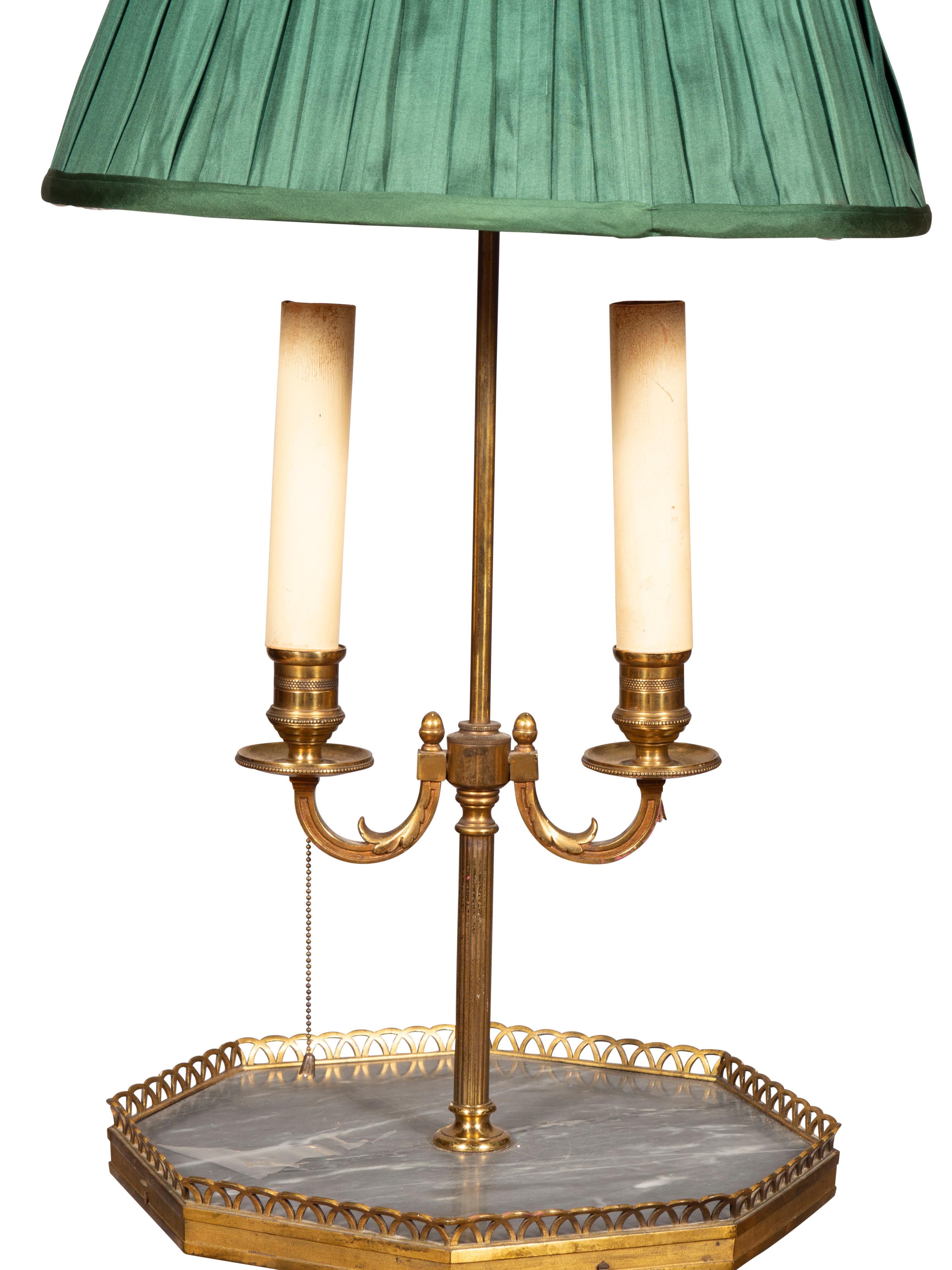 With green pleated shade. Two socket and grey marble octagonal shelf with brass gallery. Raised on three splayed legs.