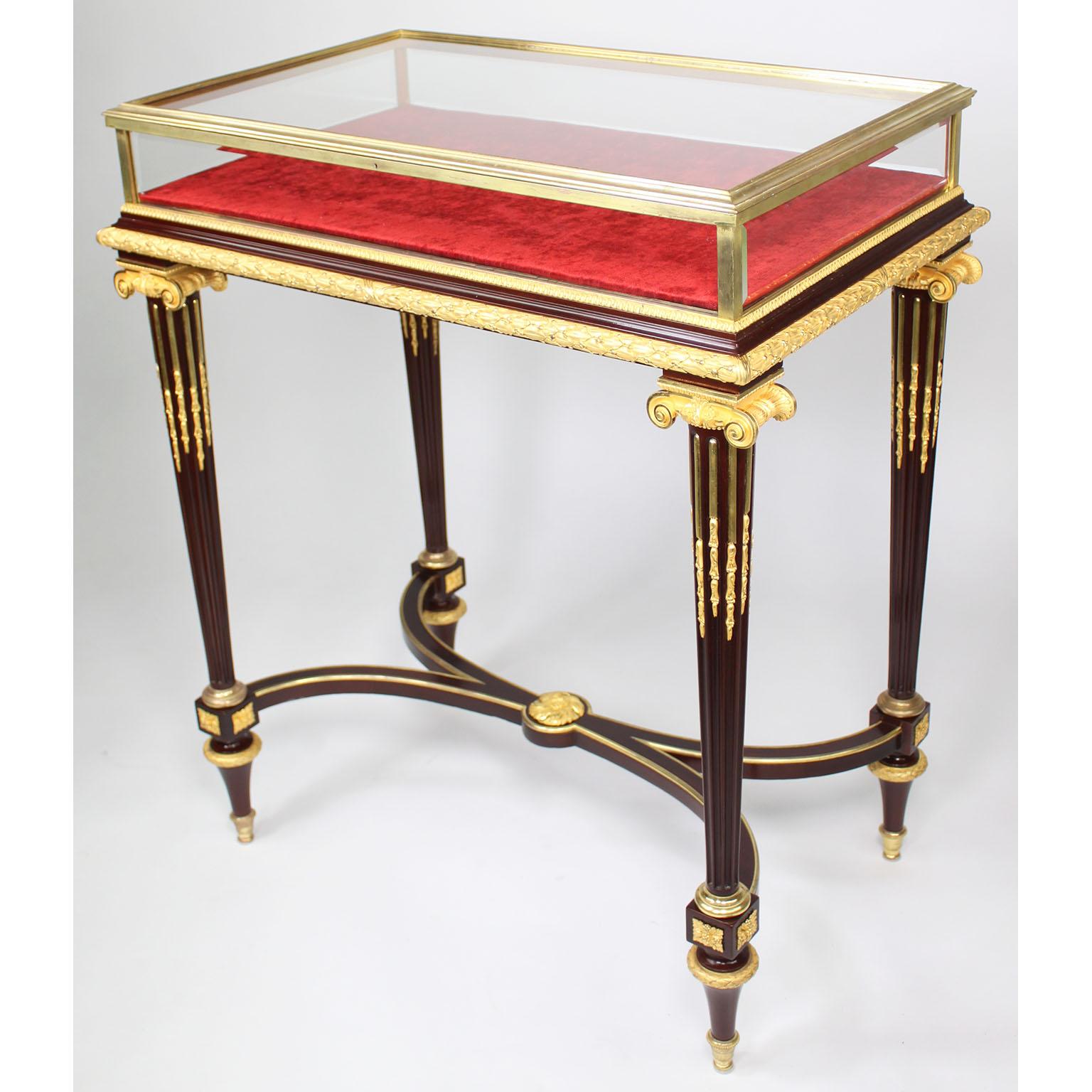 A Very Fine Museum Quality French 19th Century Louis XVI Style Mahogany and Gilt-Bronze Ormolu Mounted Bijouterie (Jewelry) Vitrine Table by Henri Dasson, with a glazed, hinged top and beveled glass sides within a molded bronze frame, opening to a