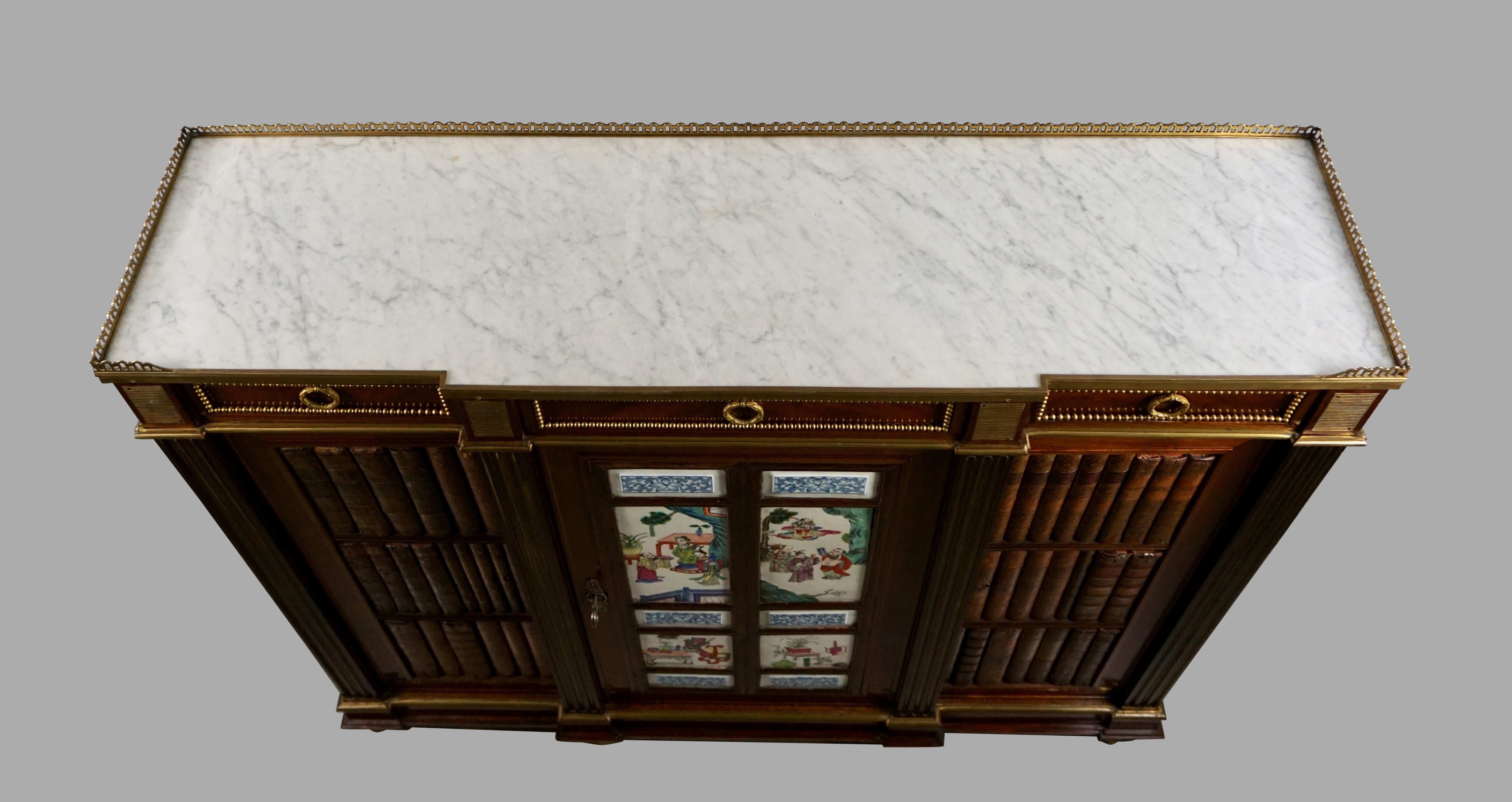 A fine quality French Louis XVI style mahogany side cabinet with a brass galleried inset carrara marble top above 3 narrow ormolu-mounted drawers. Below is a central cabinet door inset with 10 Chinese porcelain panels flanked by 2 cabinet doors