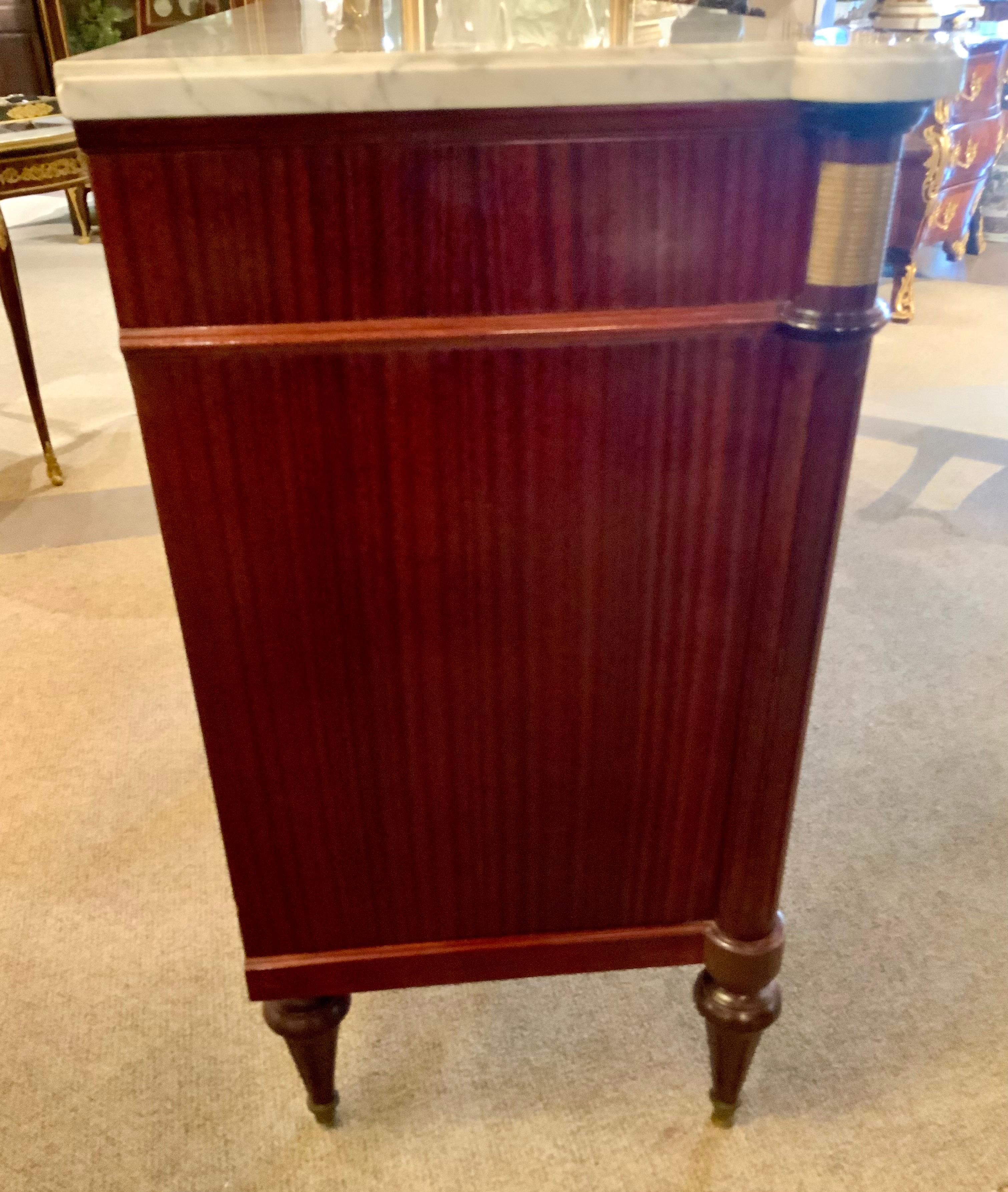 The flame mahogany used in this piece is exceptionally good
The craftsmanship in the cabinetry is extremely fine.
The hardware is a beautiful soft hue in bronze and the
Locks and keys are present and all work. The three drawers
All slide well and